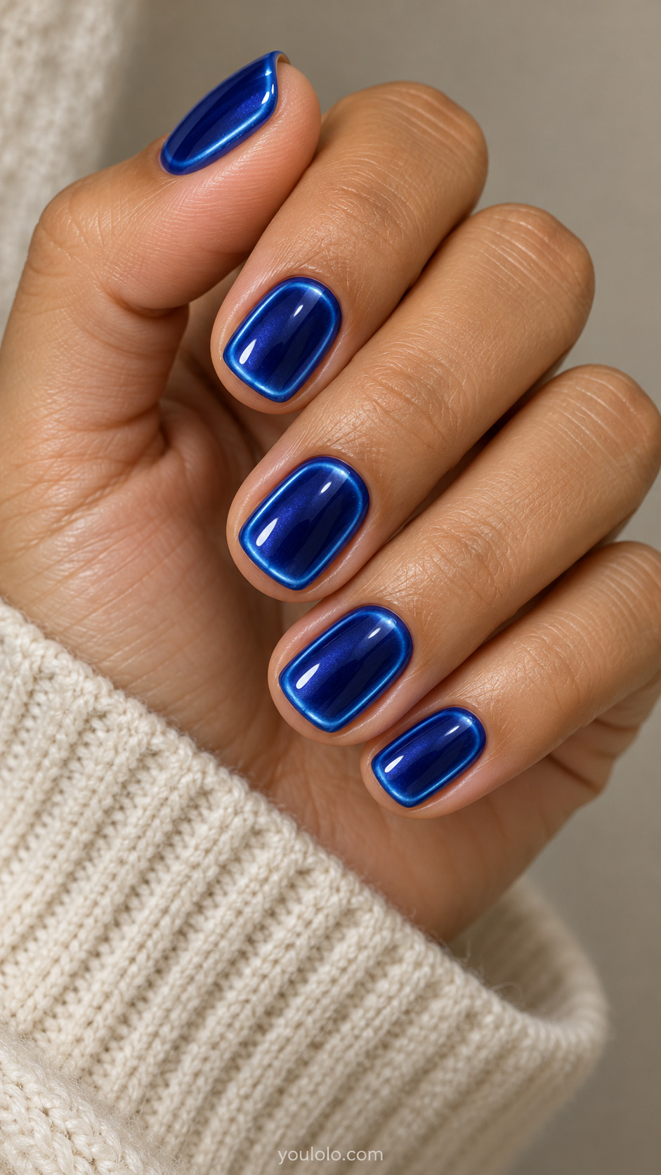 Cobalt-Light Sapphire Edge Glow on a softly gathered feminine hand with detailed sapphire blue manicure