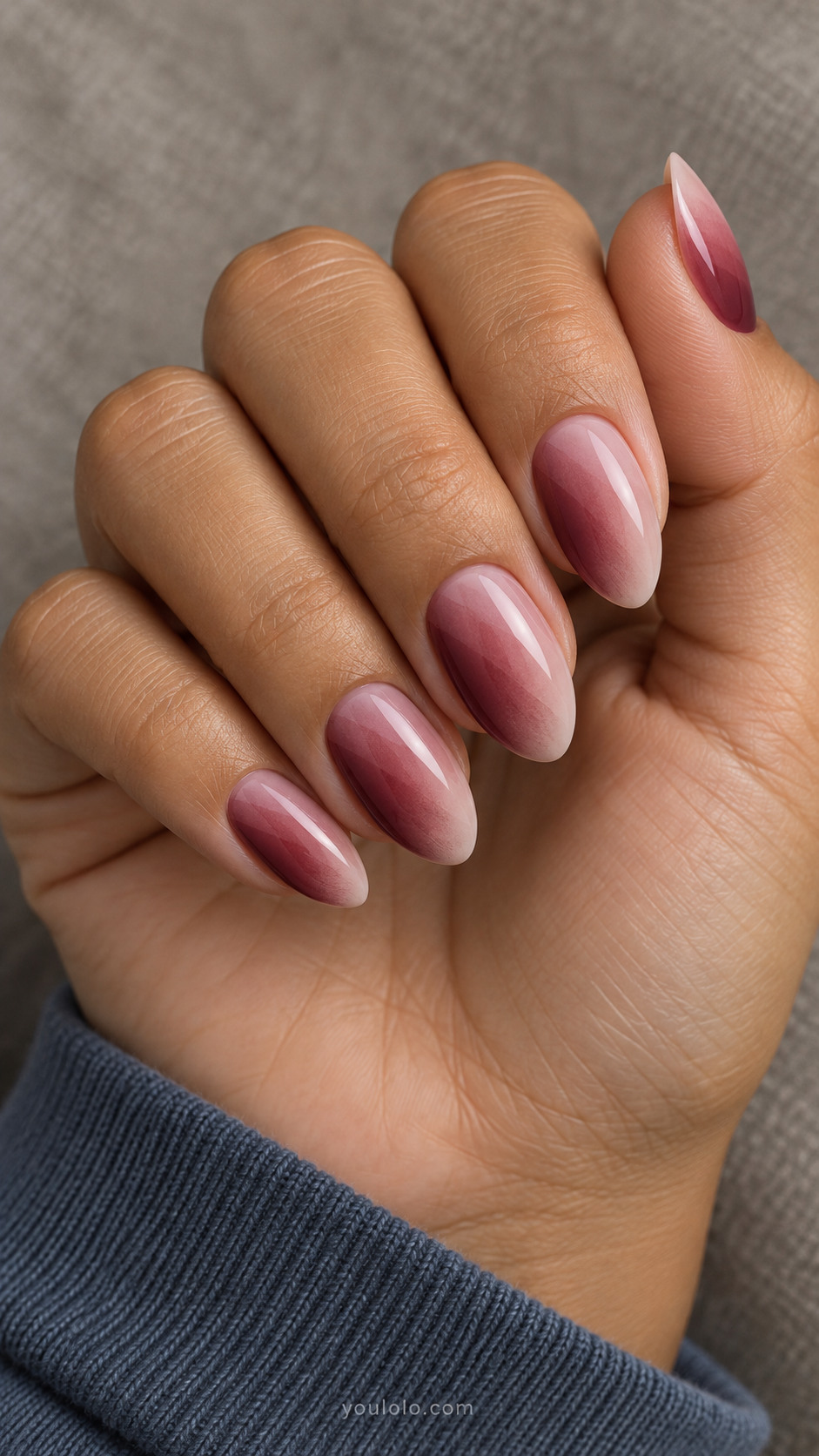 Almond nails with diagonal merlot-to-sheer-pink fades