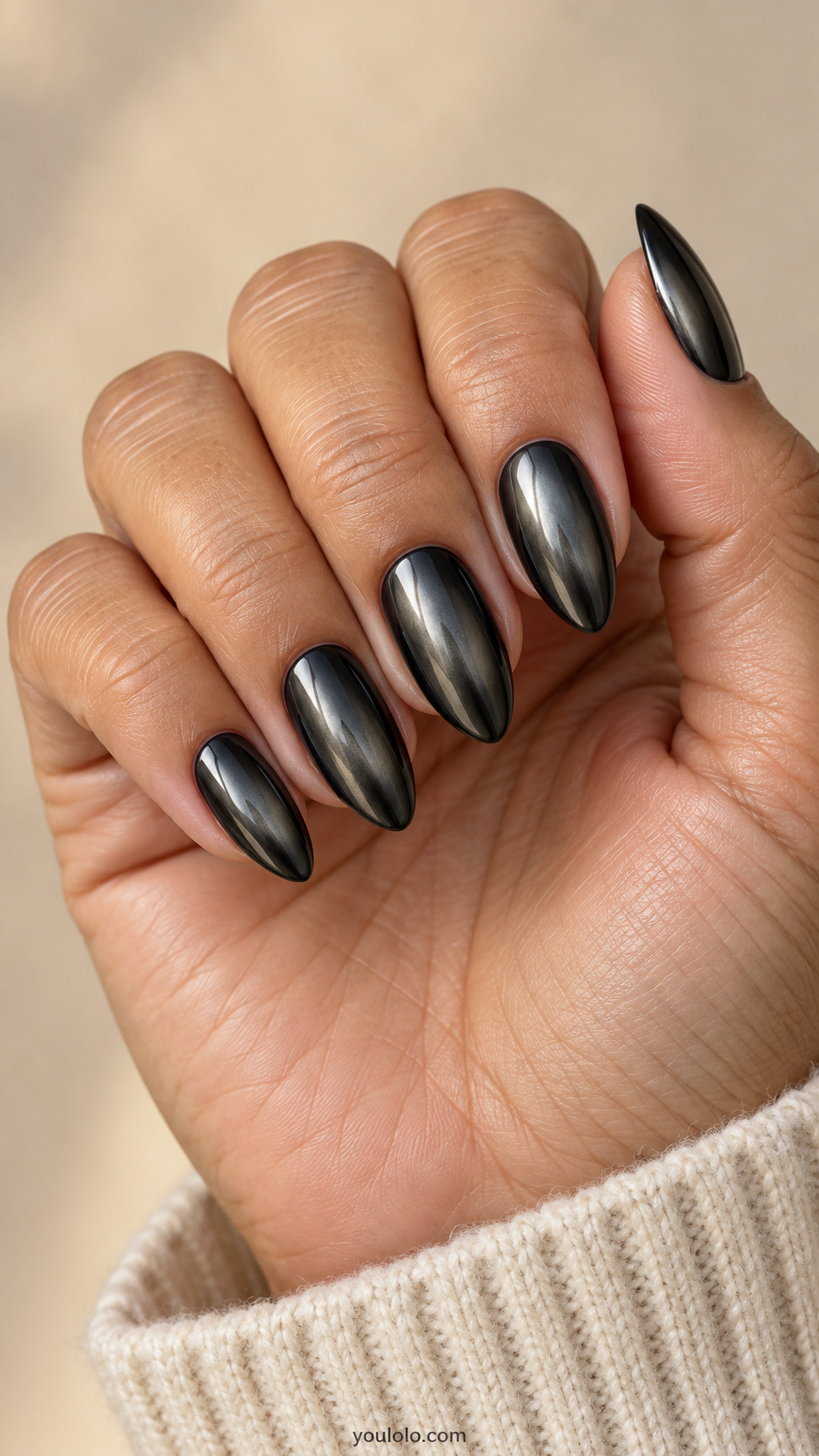 Medium almond black chrome nails with soft smoky graphite center fading to near-black edges, subtle mirror veil over the complete gradients