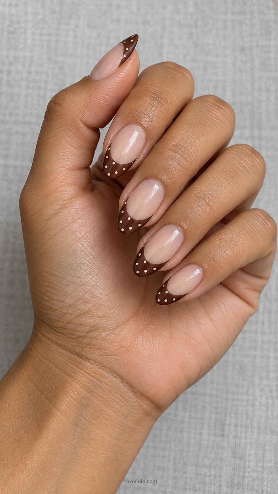 Brown Polka French — medium almond sheer beige base wide brown French tips with tiny ivory dots only on tips