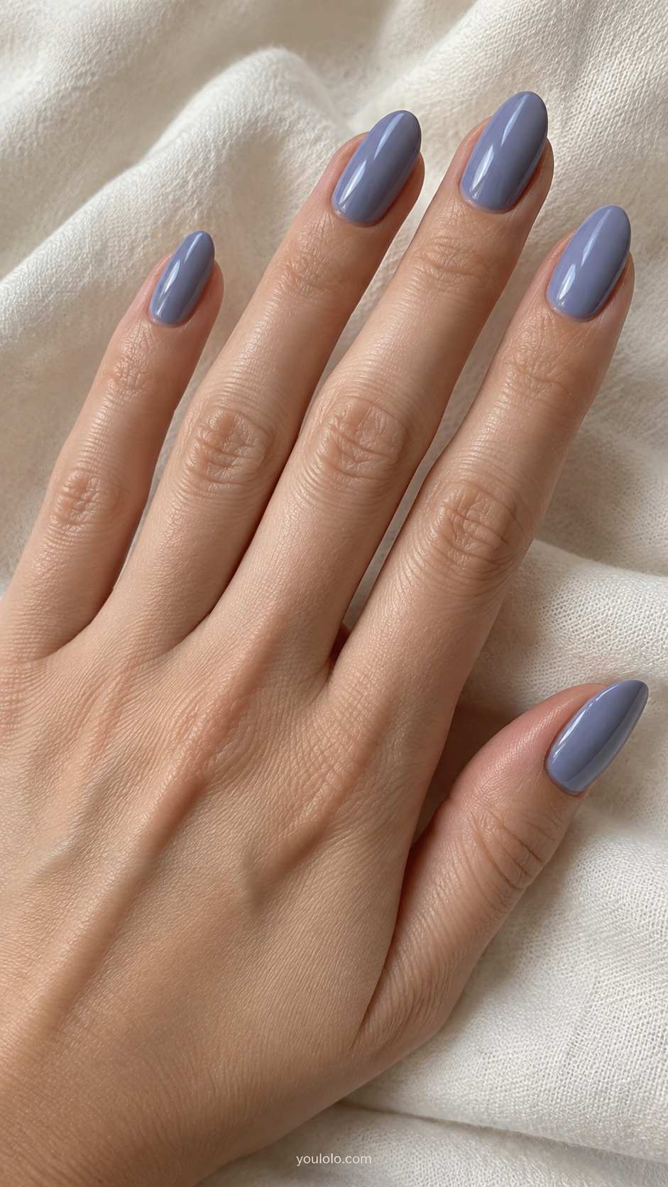 Medium almond nails dusty periwinkle blue with subdued violet undertone cream gloss