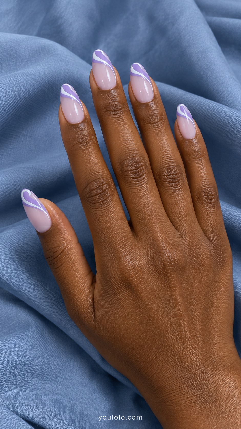 Medium almond acrylic nails milky lavender base with lilac and white intertwined painted ribbon curves at tips