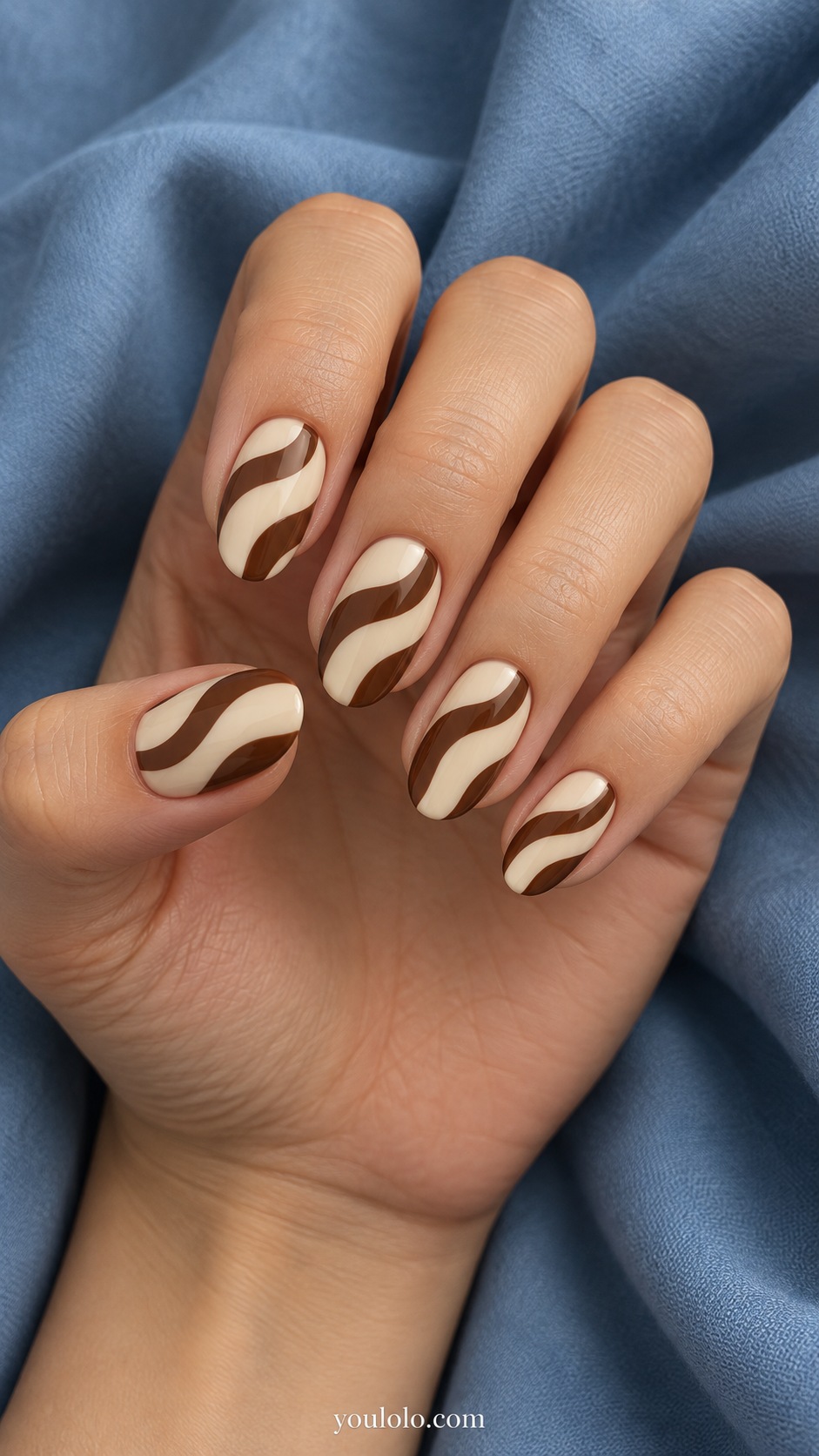 Medium oval nails butter cream base two broad curved chocolate waves per nail