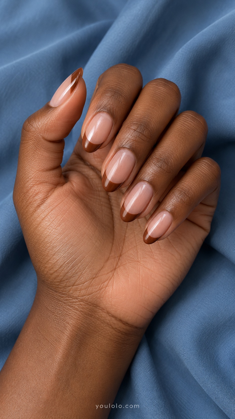 Medium oval nails sheer neutral pink base warm cinnamon brown French tips with subtle pearl glaze