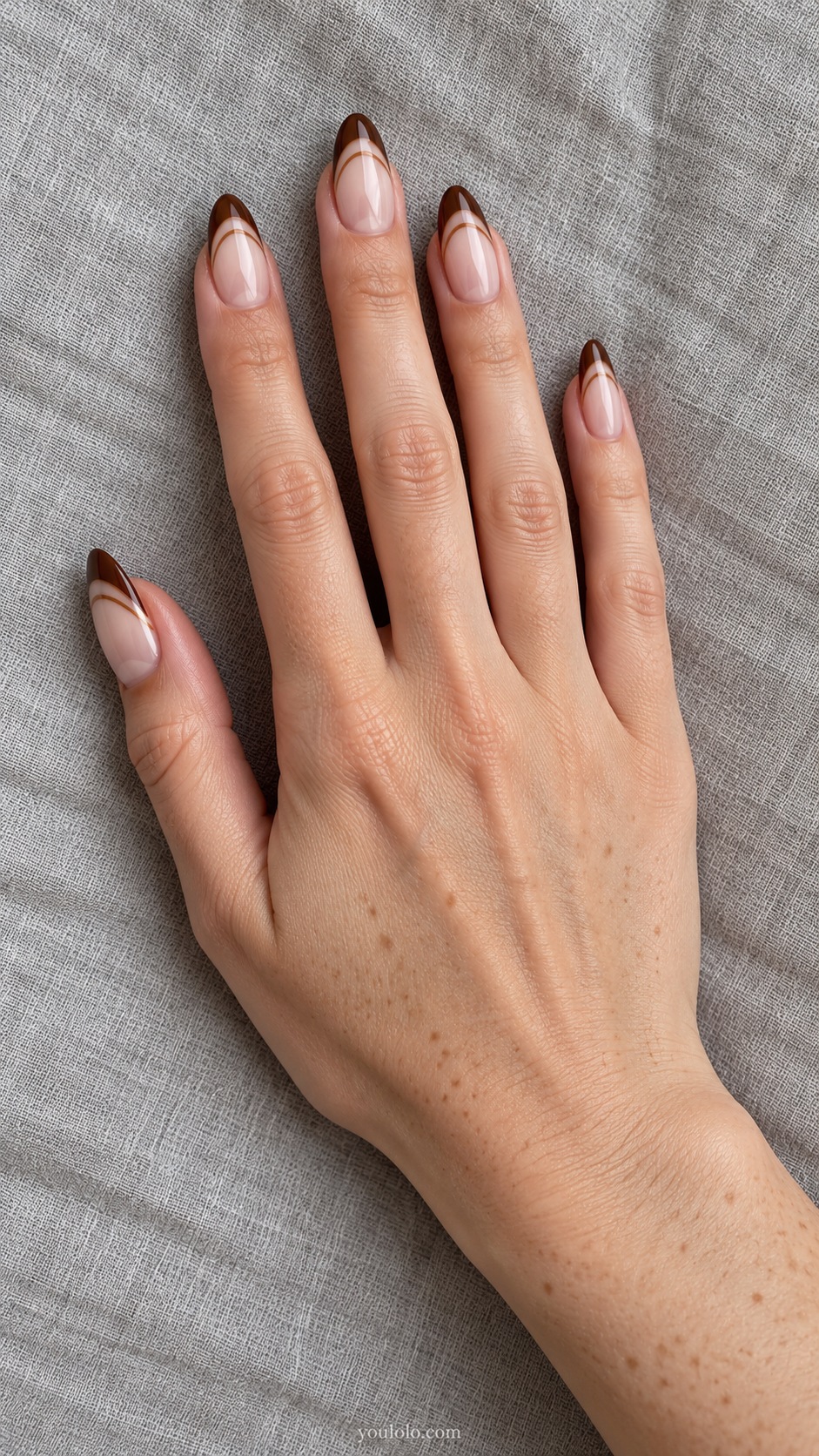 Medium almond sheer nude pearl nails chocolate glazed french tip plus separate fine caramel curved smile below