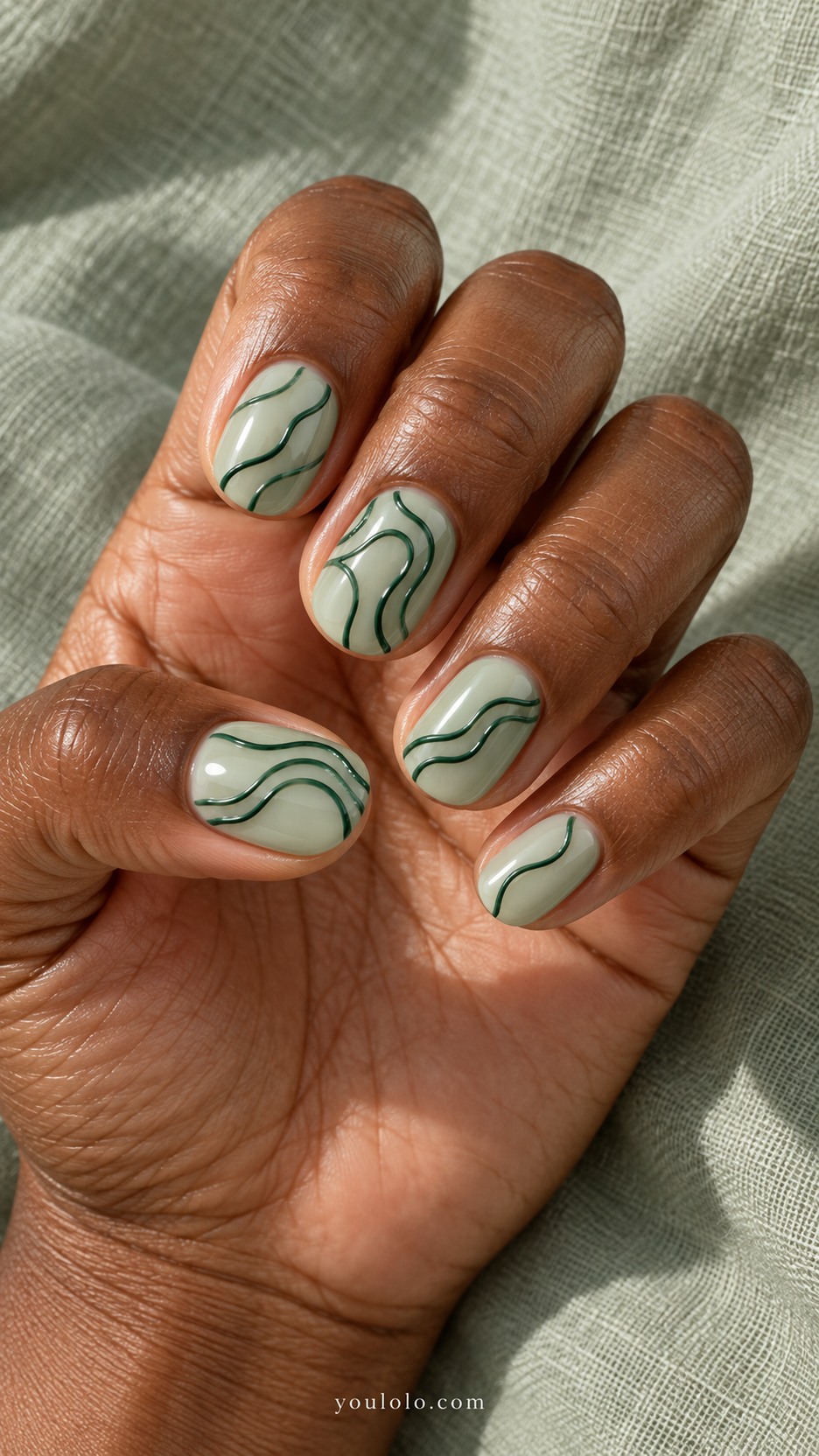 Jade Topographic Contours — Short rounded nails, milky pale jade base, dark emerald thin raised contour lines following asymmetric topographic landforms on all nails, generous pale gaps, glossy relief