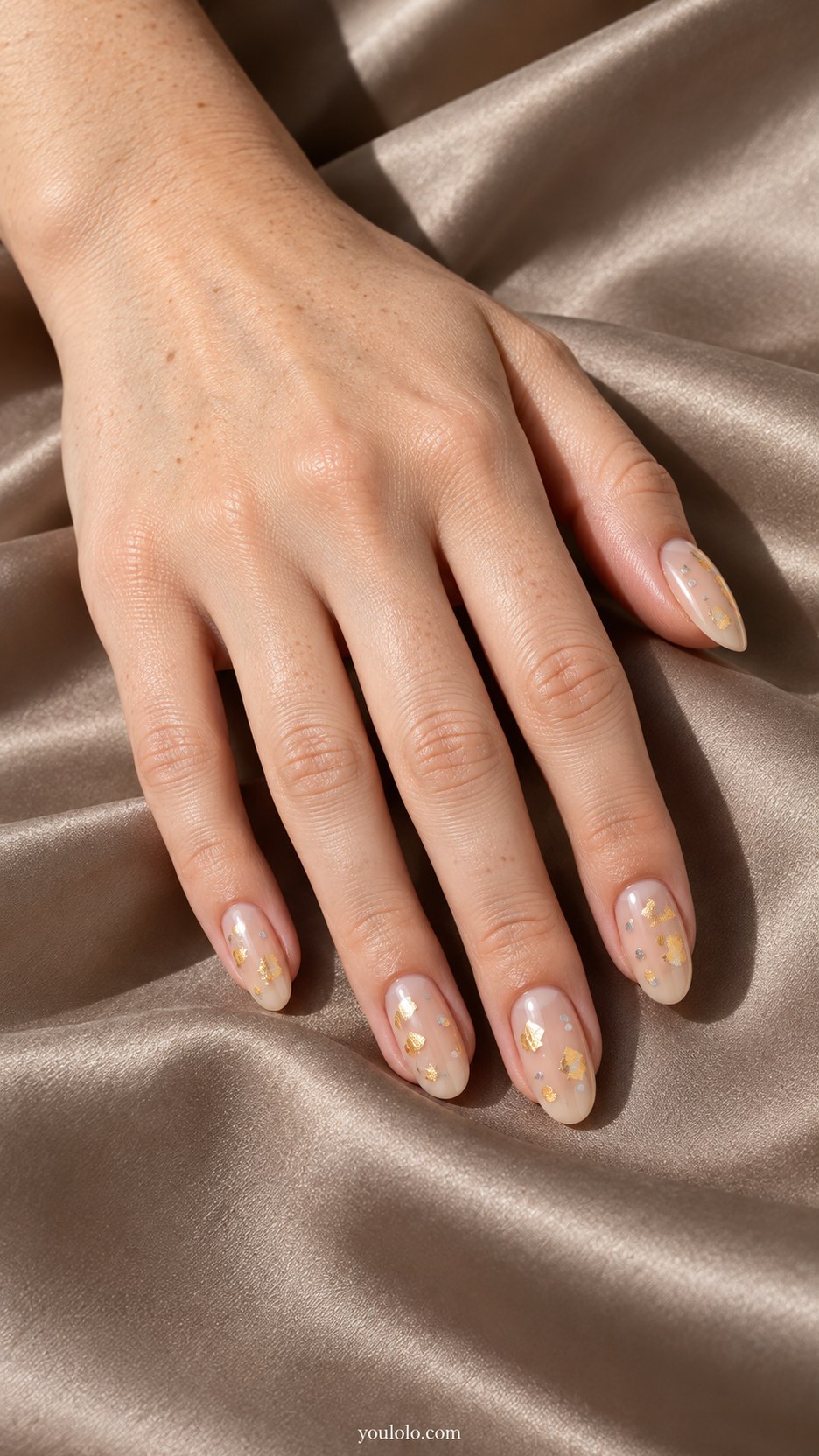Gold Foil Silver Dots: medium oval sheer beige nails, sparse flat warm gold foil flecks and small flat silver dots