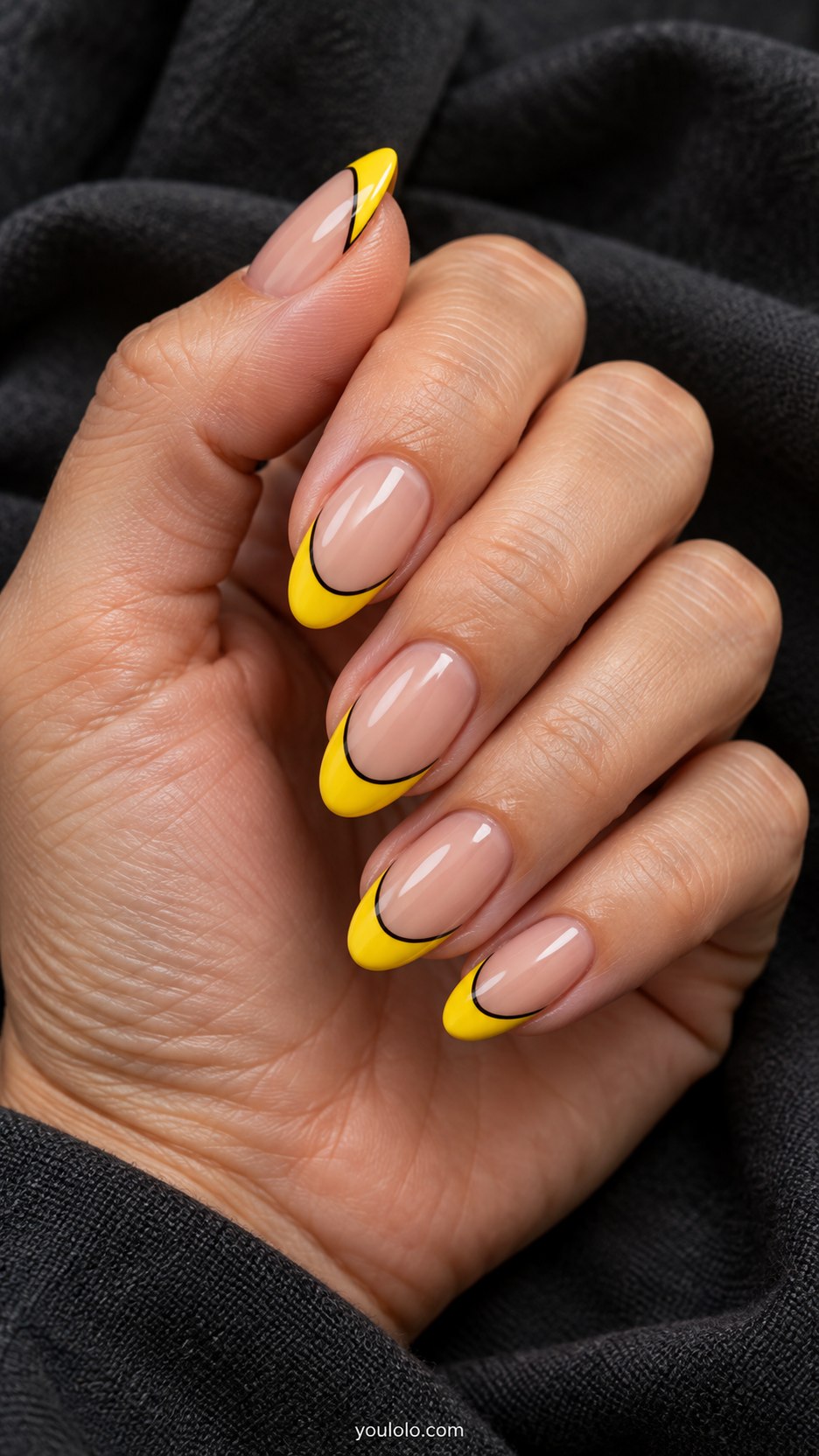 Yellow Pop-Art French: medium almond nude nails, bright yellow French tips with black outline and white painted glint