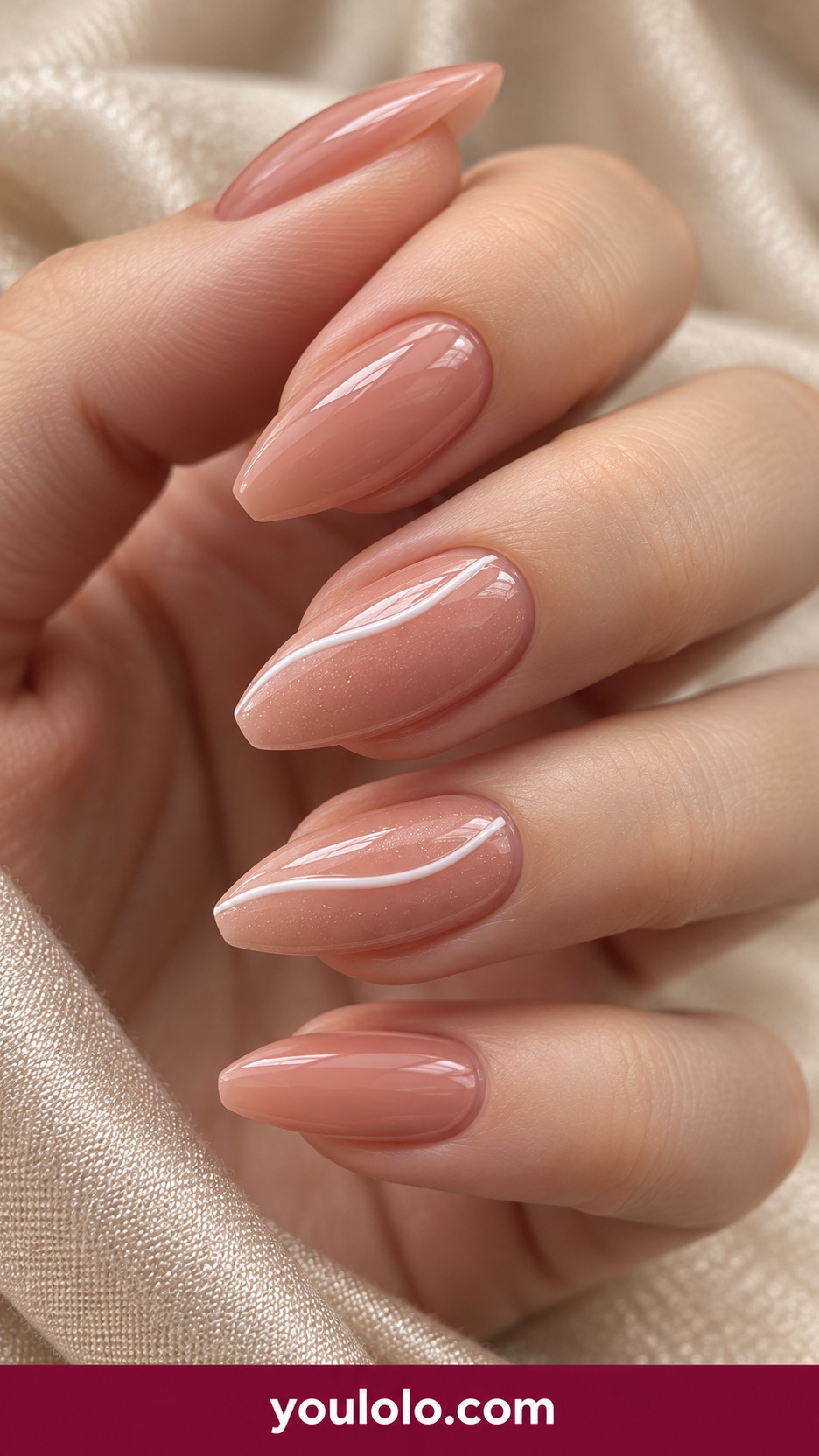Medium almond blush nude nails with a slim low raised white gel ribbon curve on two accents and plain glossy other nails on a naturally curled young adult hand