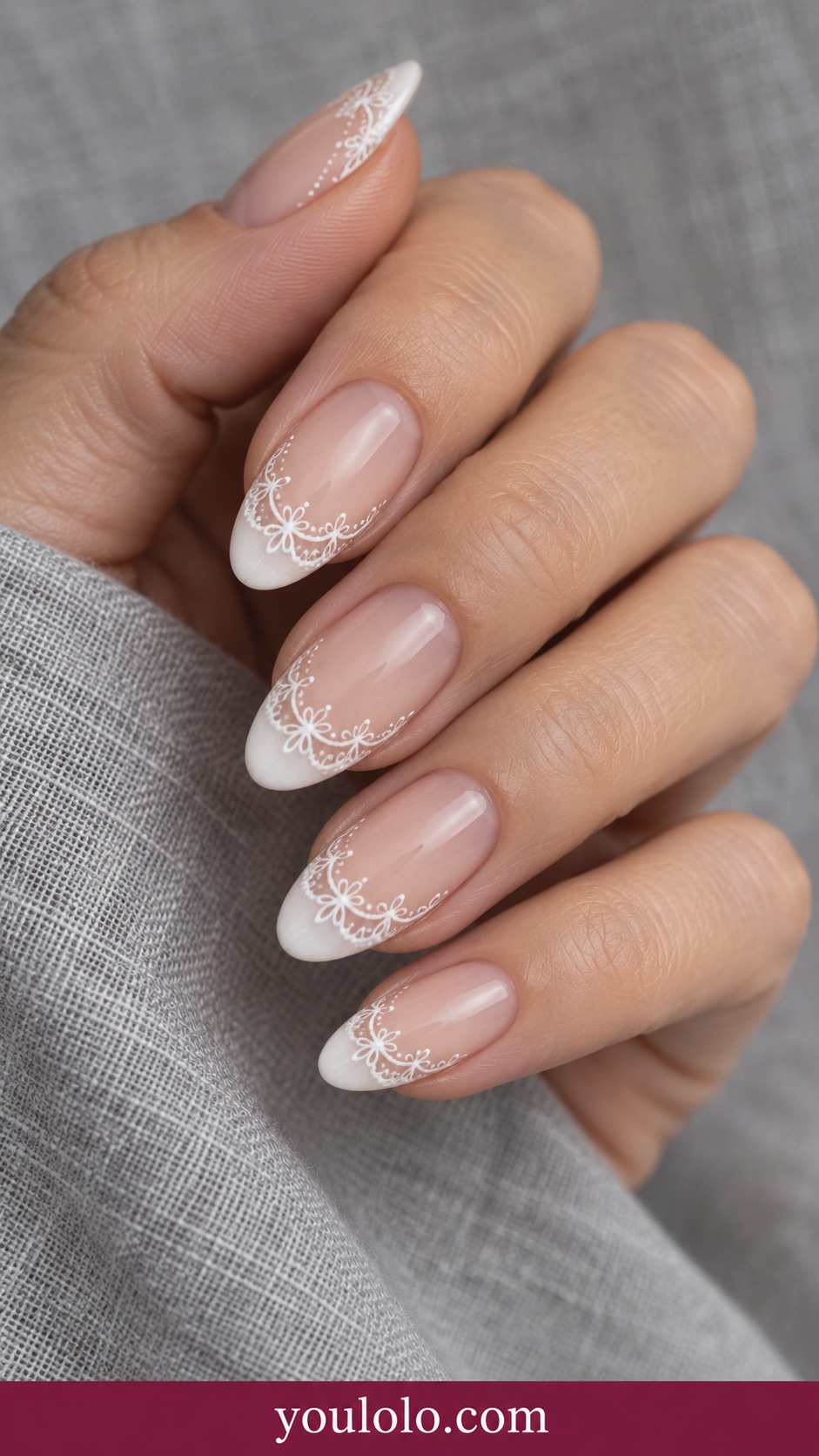 medium almond sheer nude nails delicate white open lace scalloped tips, small fine loops and dotted accents on a naturally relaxed adult hand