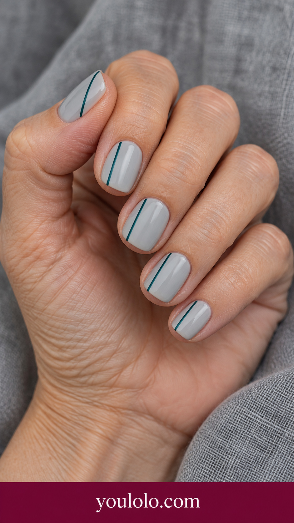 Teal Pencil Line: short soft square pale gray nails one extremely fine vertical teal line offset toward one side on a naturally posed adult hand