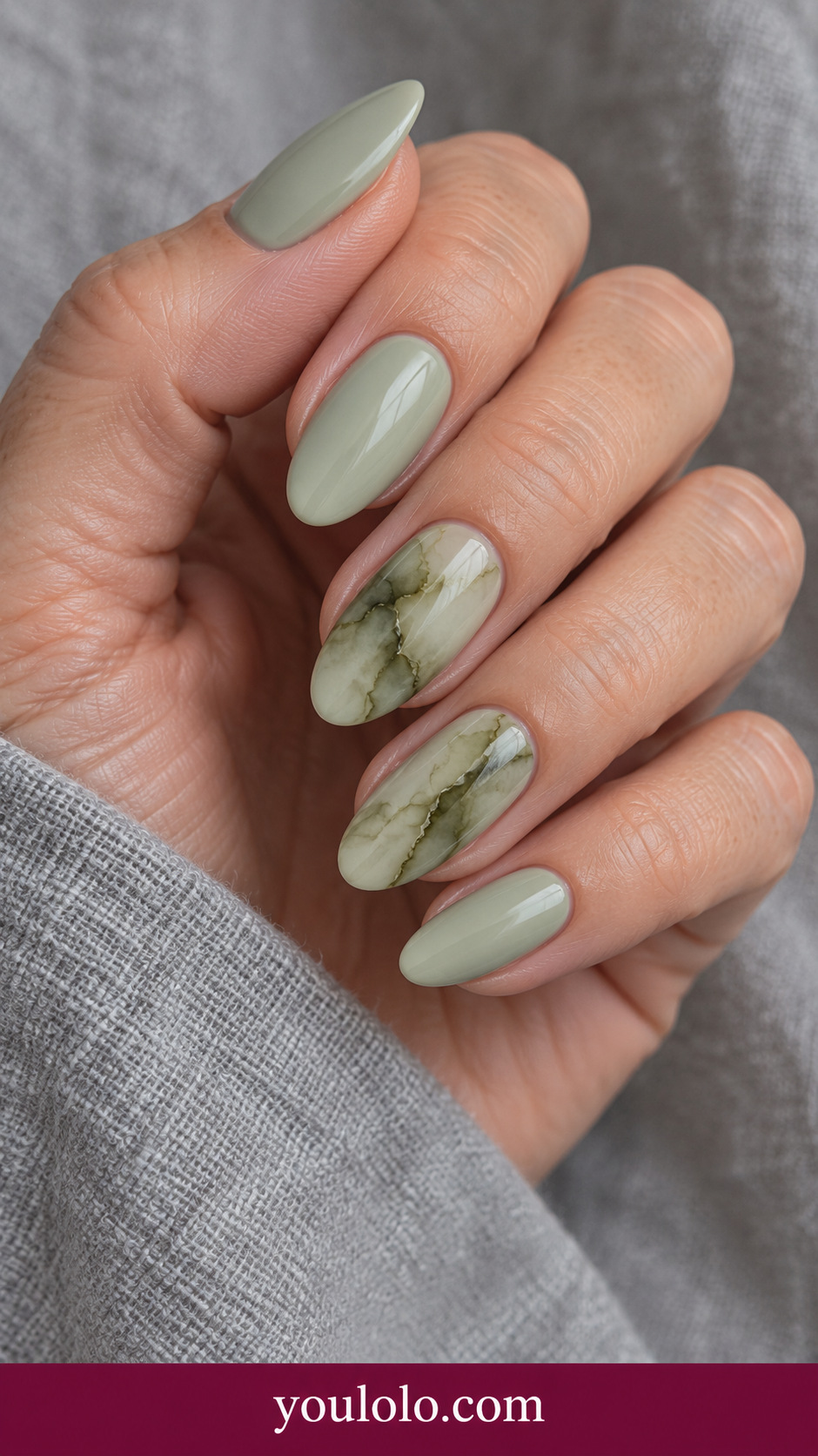 Moss Stone Veins: medium almond pale sage nails two accents soft dark olive blooming irregular stone veining on a naturally posed adult hand