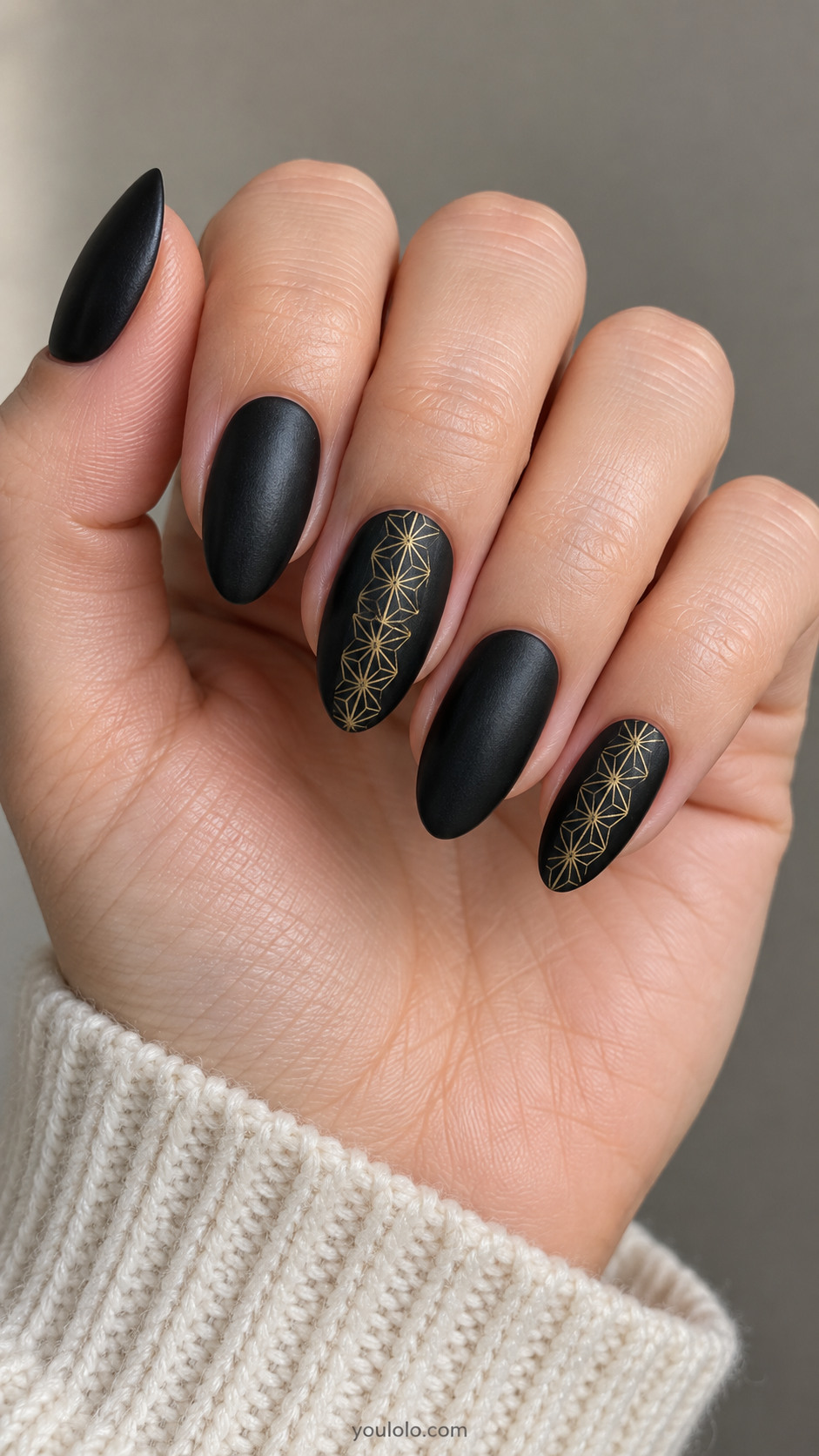 Satin-black almond nails with fine gold asanoha panels on two accents