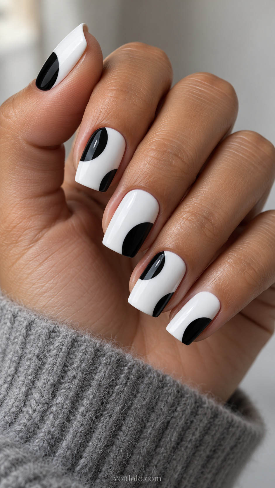 Medium square white nails with two enormous black circles partially cropped at opposite side edges, white center gap, clean geometric