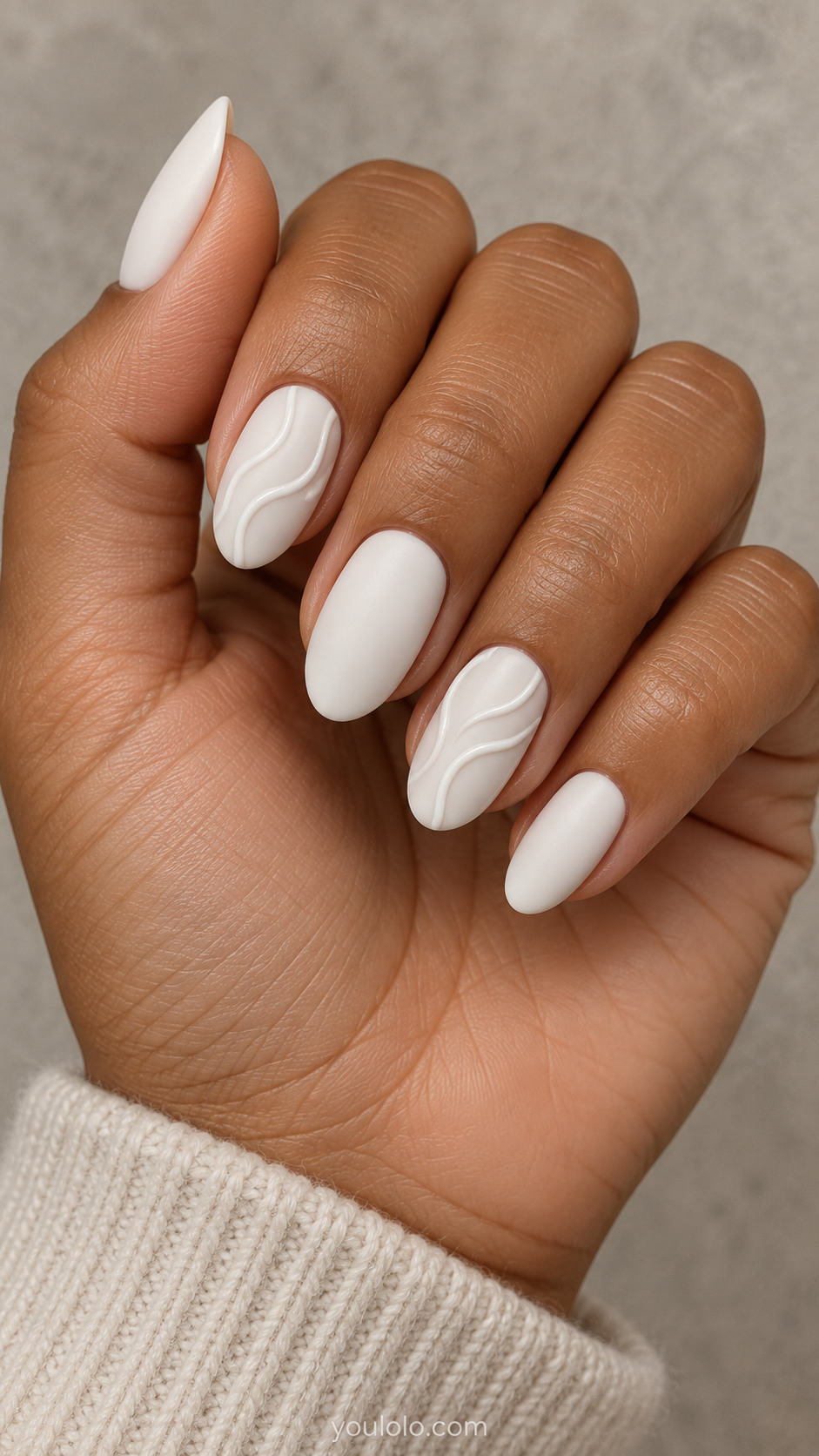 Matte white almond nails with raised glossy white flowing lines on two nails