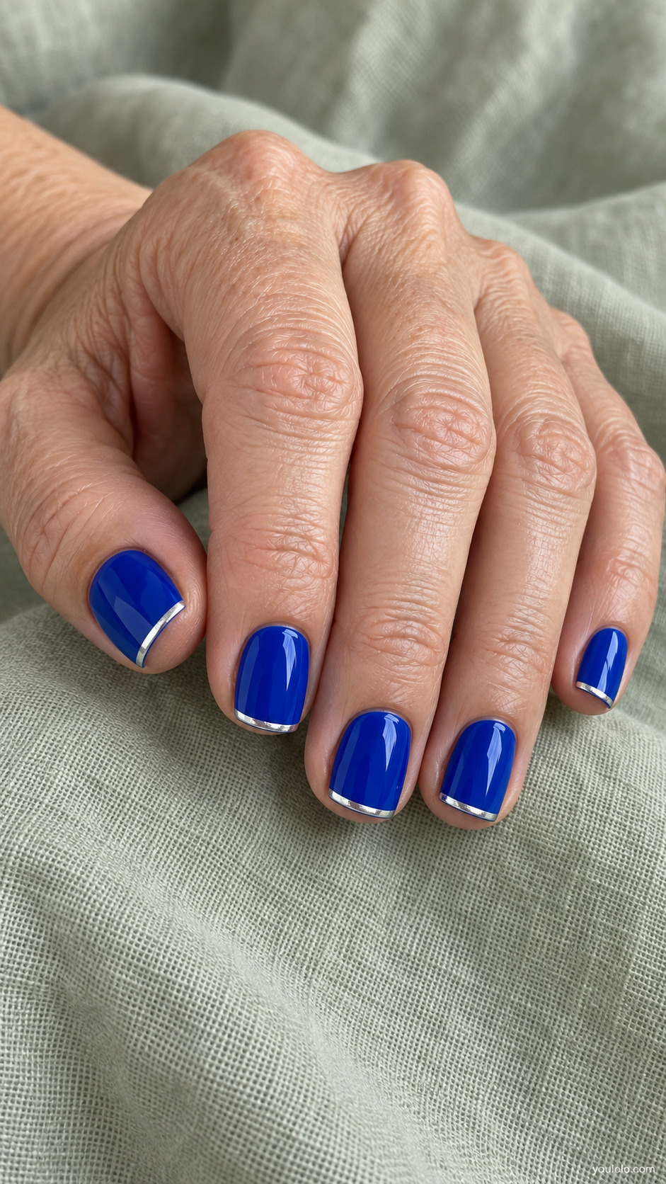 Short square royal blue nails with fine silver metallic tips