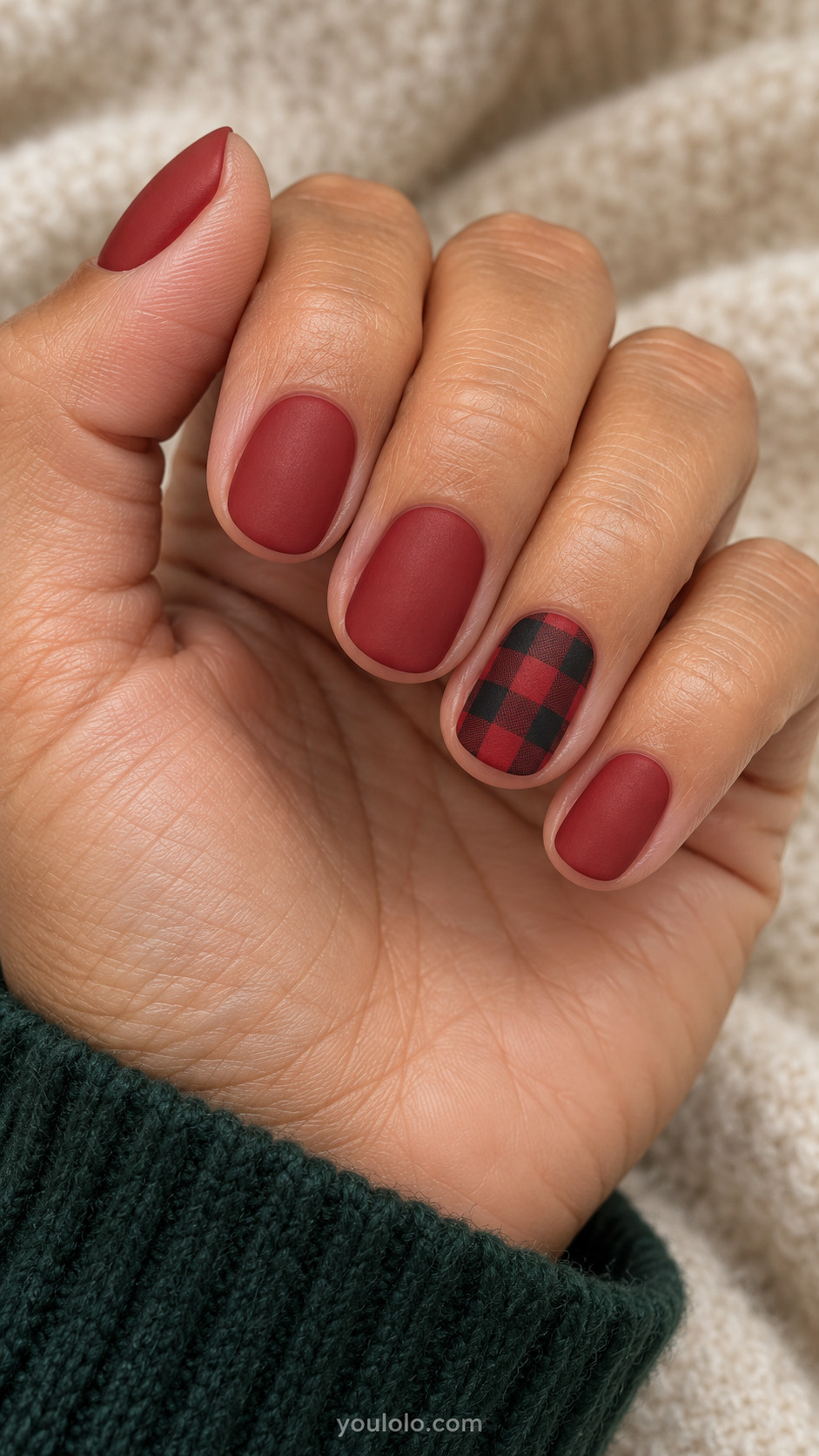 Matte brick-red oval nails with one small-scale buffalo check accent