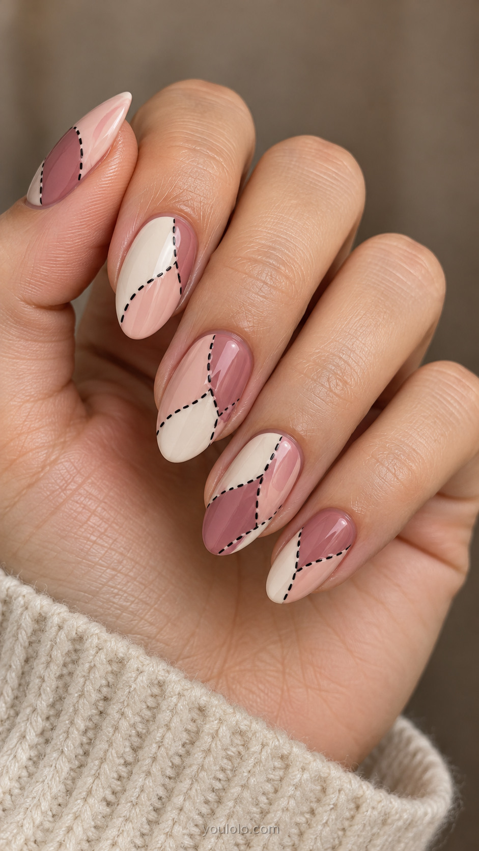 Almond nails with blush, cream and dusty rose patches joined by black stitches