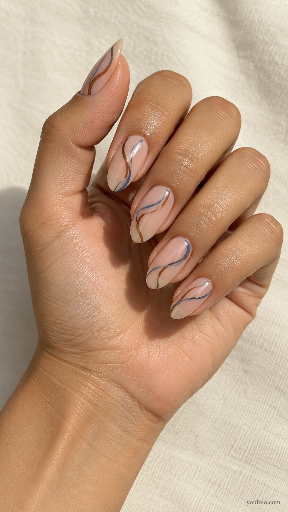 Sky and Coffee Swirls — medium almond sheer beige nails one blue and one coffee brown fine curving ribbon each nail