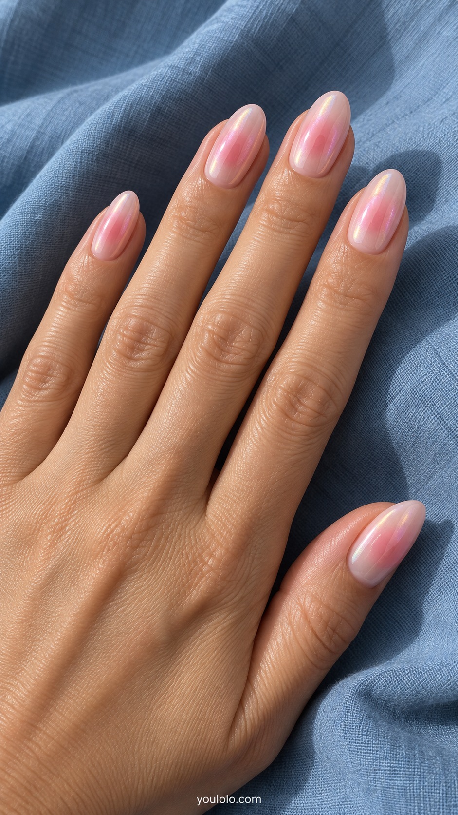 Medium almond nails milky pink base with diffused rosy pink aura center and fine pearlescent glaze on all nails