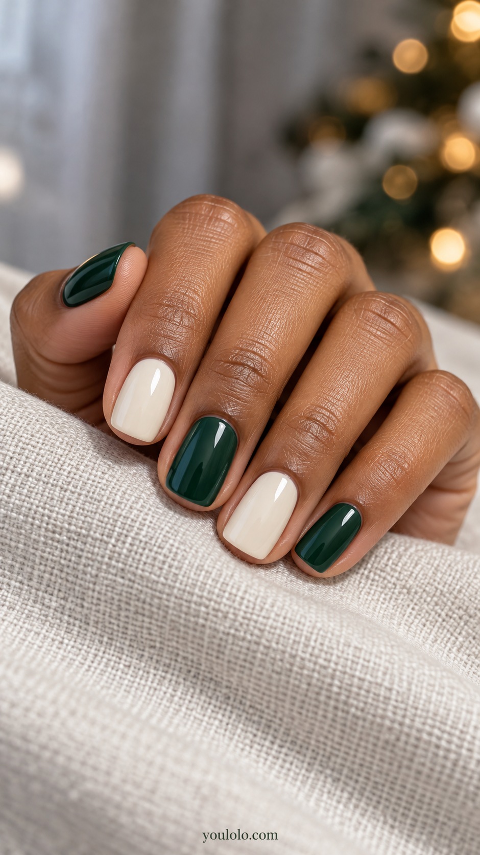 Short squoval alternating emerald green and creamy ivory nails no art
