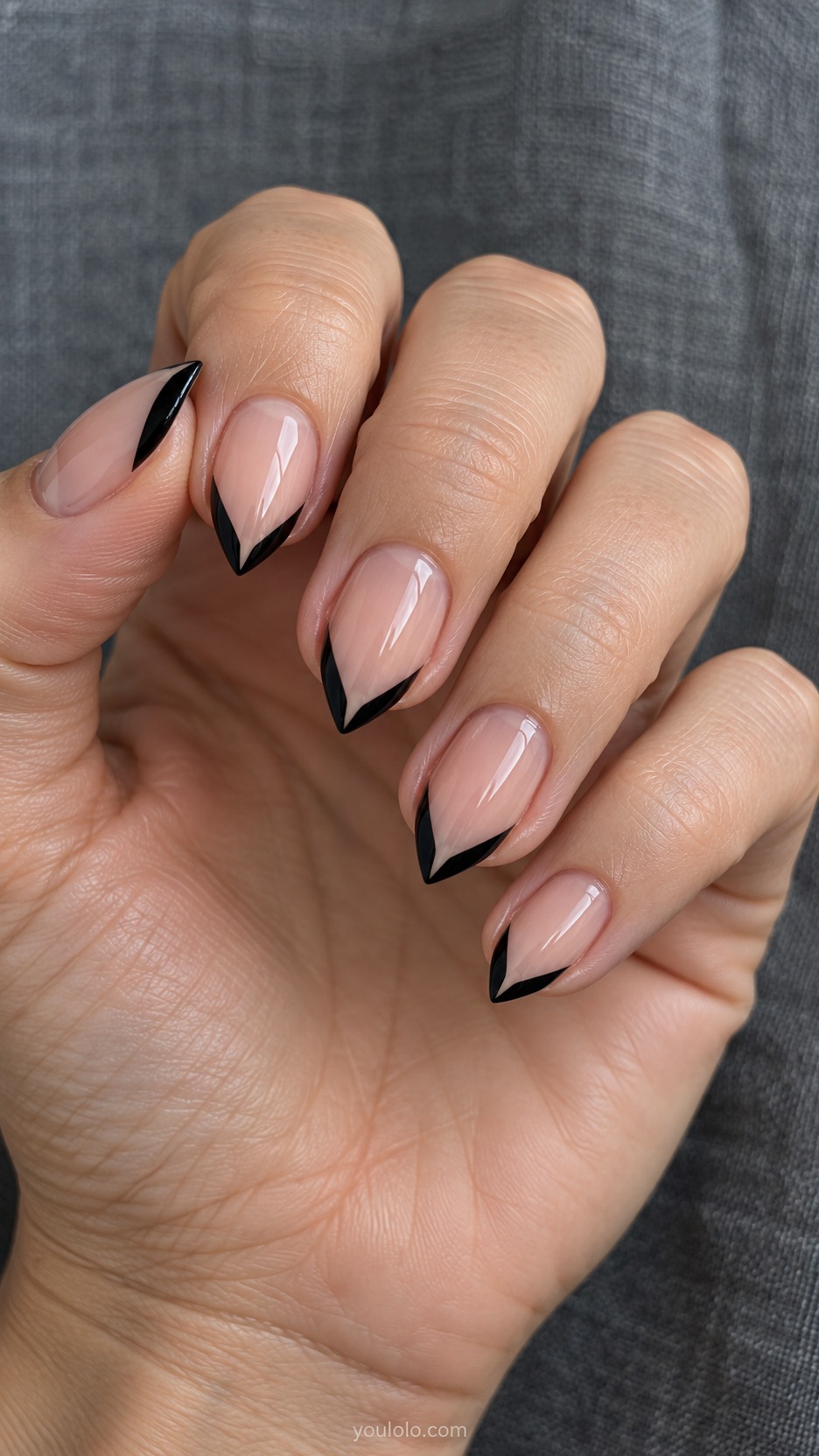 Short Stiletto French Nails: Black Negative-Space V manicure on a naturally posed hand