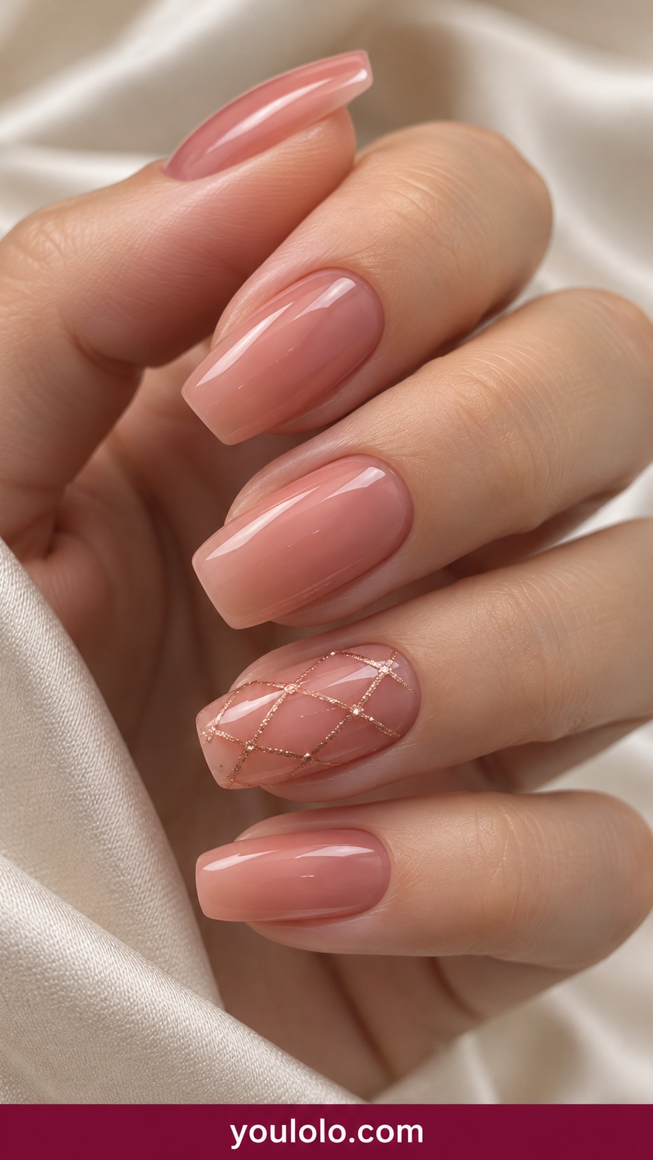 Medium square sheer warm pink nails with fine rose gold open lattice on one accent only on a naturally curled young adult hand