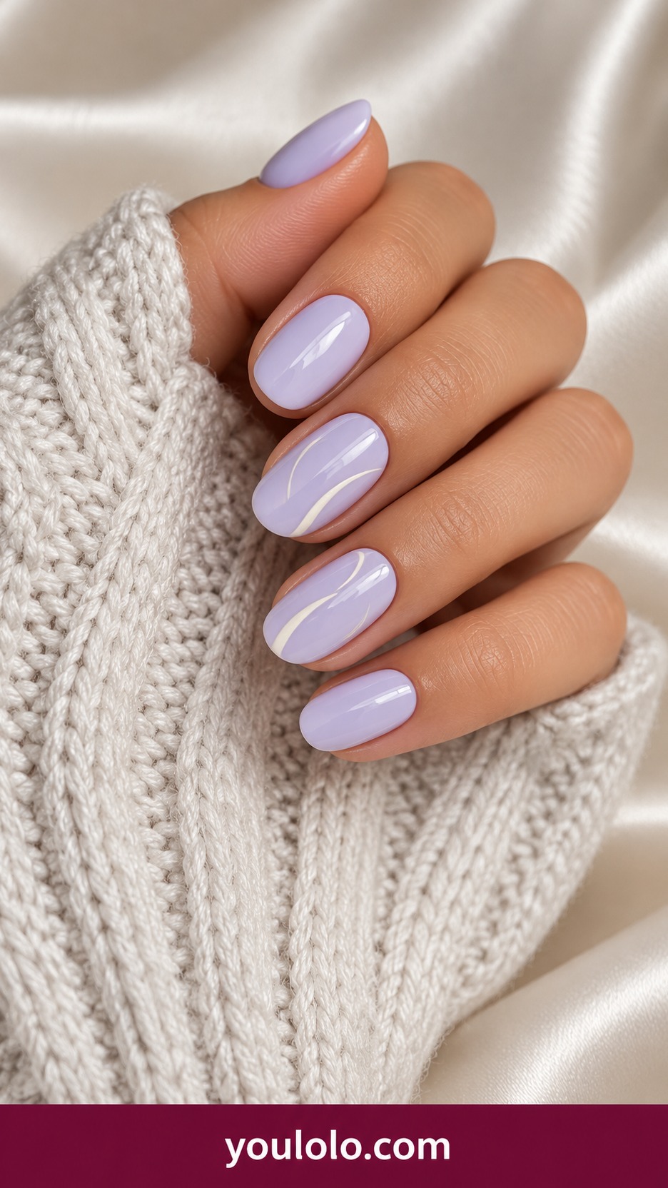 Short squoval soft lilac nails with two fine cream abstract brushstroke arcs on accent nails on a naturally curled young adult hand
