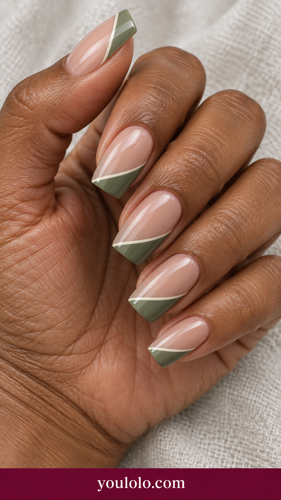 medium square nude beige press-on nails sage green diagonal French tips with very fine ivory separator on a naturally posed adult female hand
