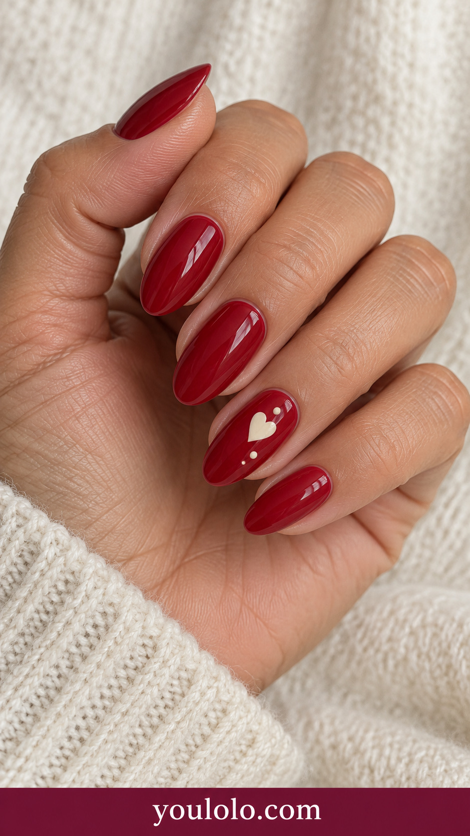 Cherry Heart Dots: medium almond cherry red nails one accent ivory heart surrounded by three tiny ivory dots on a naturally posed adult hand