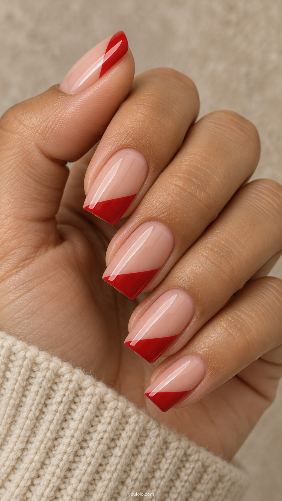 medium soft-square nude nails, vermilion red diagonal slanted French tips, same direction on a naturally gathered hand
