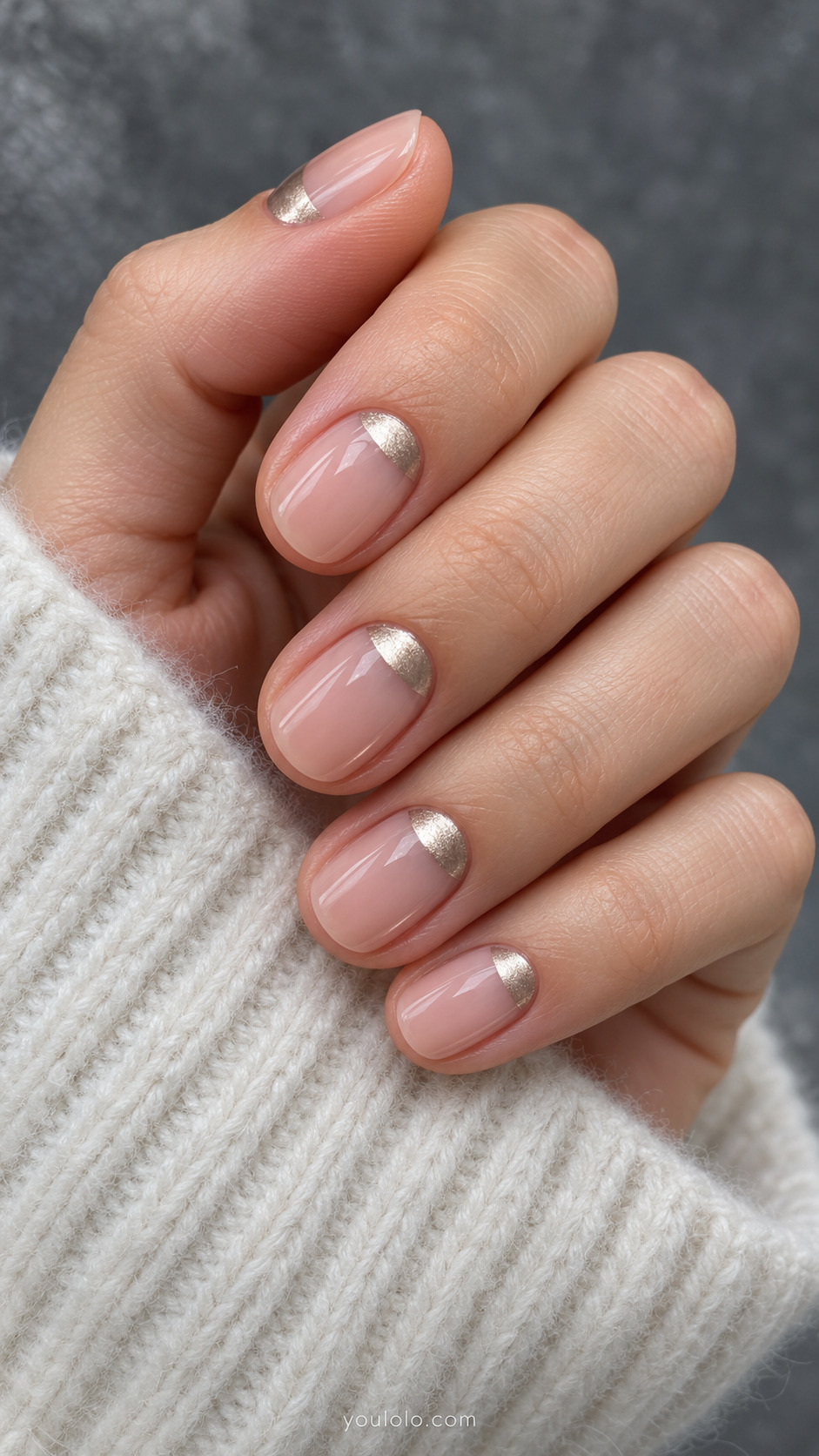 Blush rounded nails with small pale champagne metallic half-moons at the base.