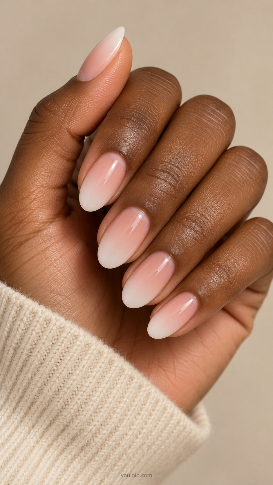Medium softly tapered oval nails with a soft blush pink to milky white gradient.
