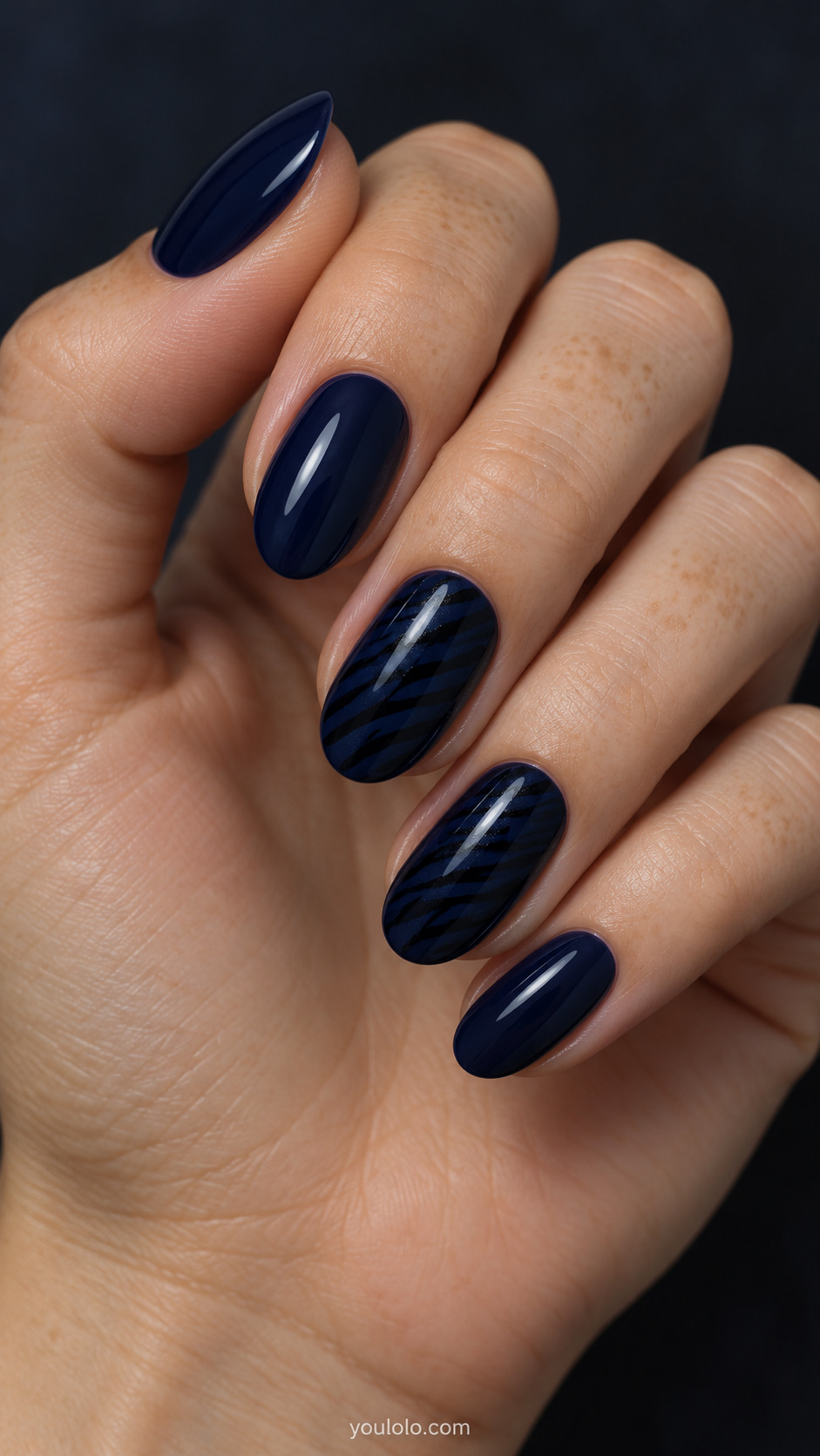 Tonal Midnight Zebra Accent on a naturally posed hand, showing dark blue polish and detailed nail art