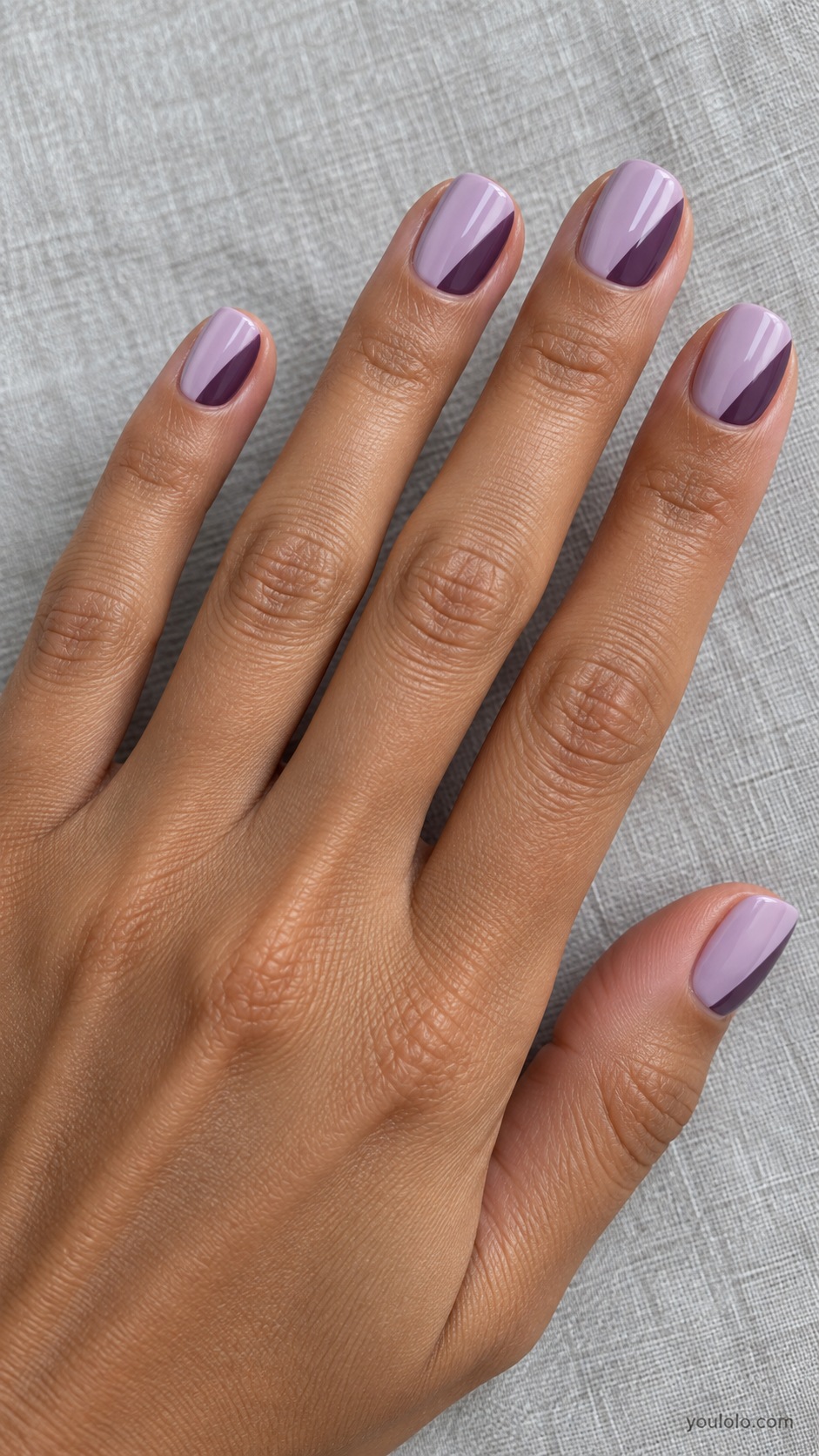 Short squoval nails pale lilac cream with smoky plum diagonal blocks covering outer third