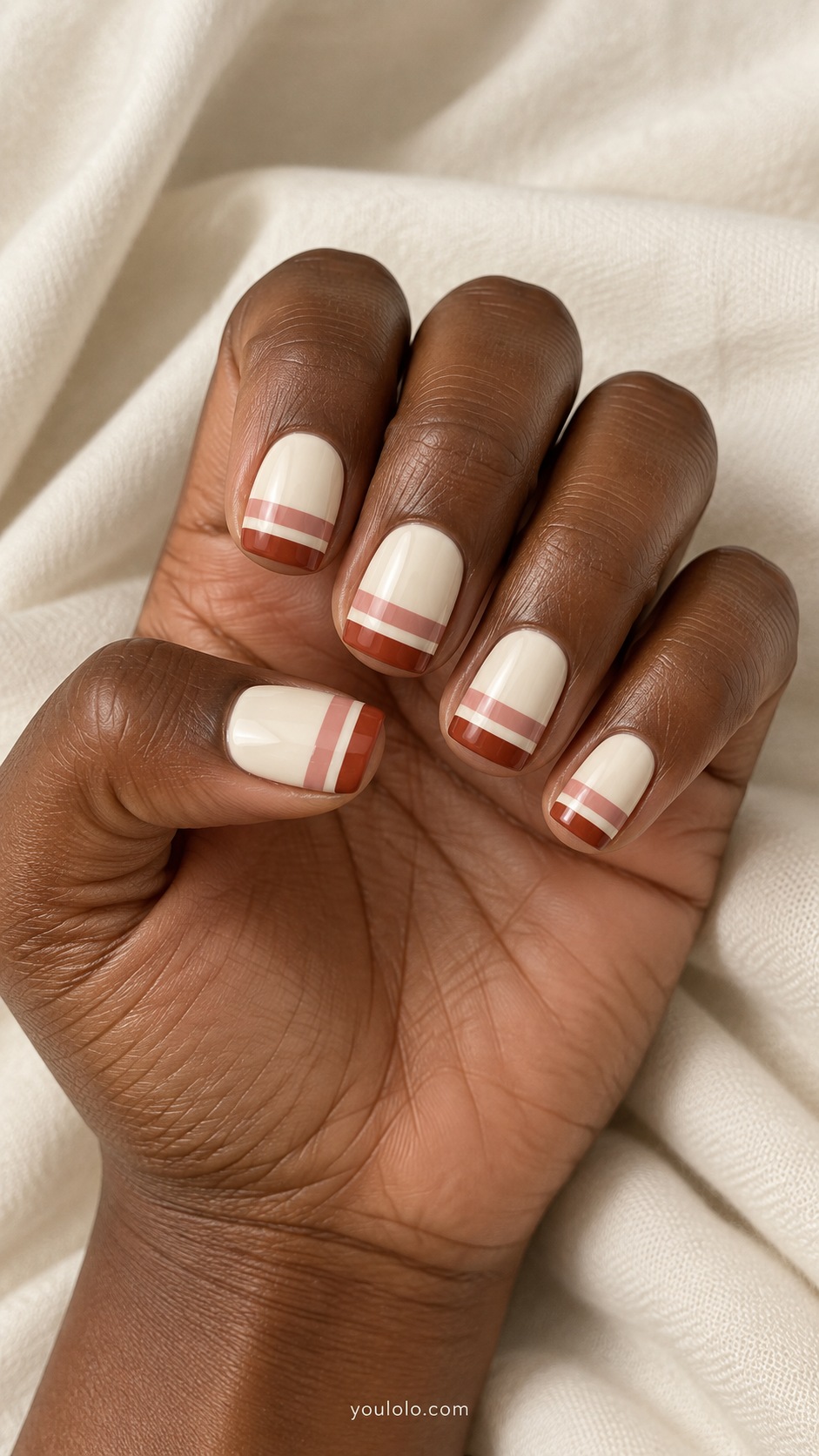 Short rounded square nails ivory base rust and dusty pink horizontal stripes near tips