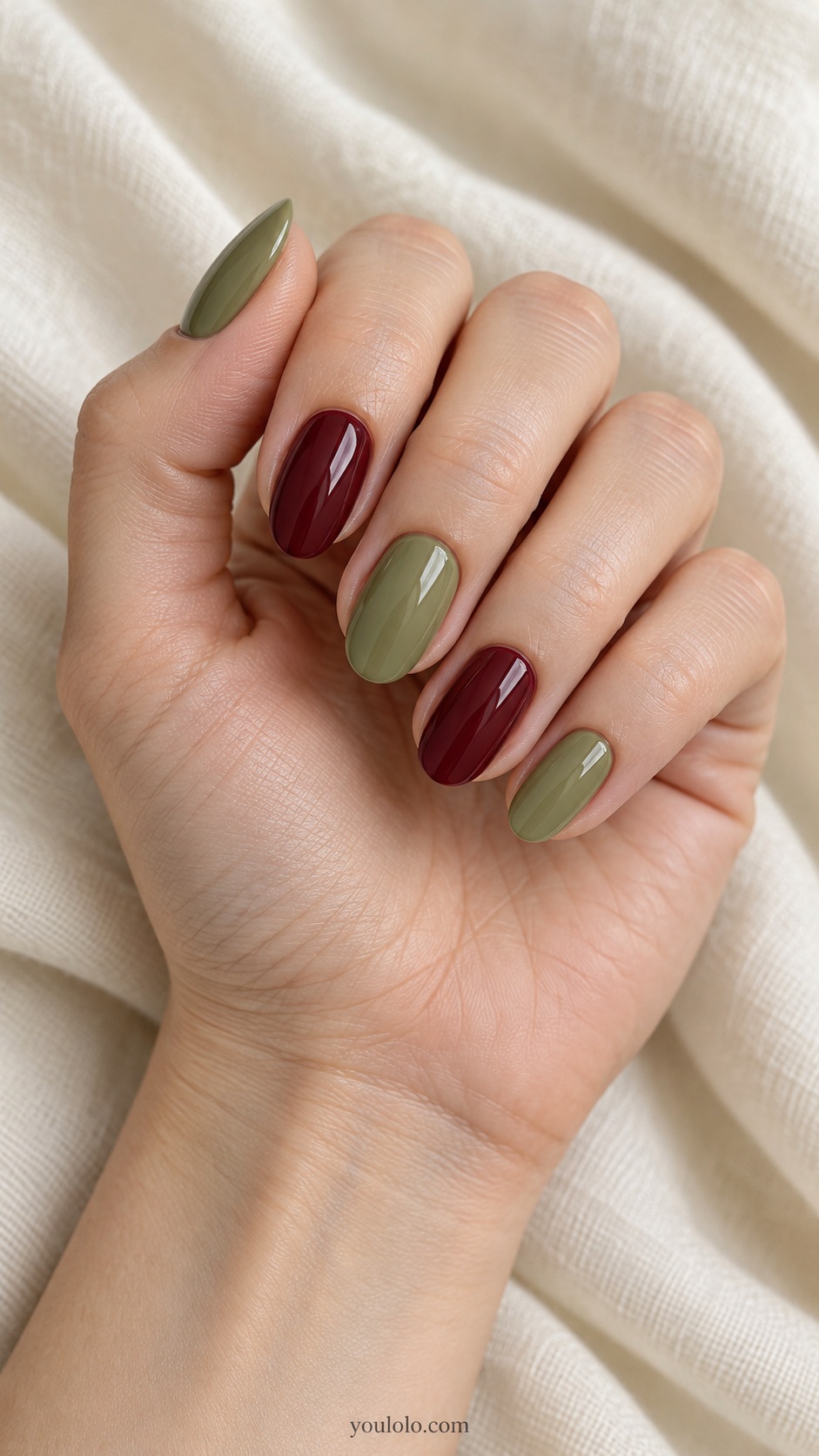 Medium oval nails muted pear green thumb middle little burgundy index ring glossy