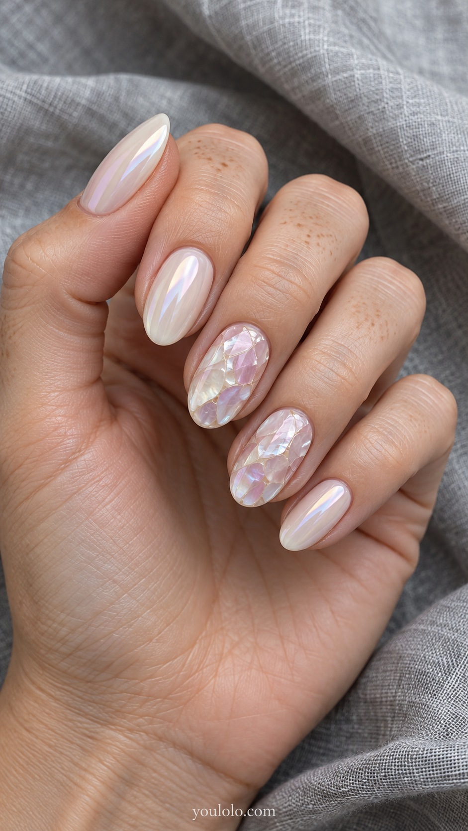 Medium oval nails milky ivory pearl glaze, ring and middle nails with flat irregular pale pink lavender and cream mother of pearl shell mosaic panels separated by hairline ivory seams