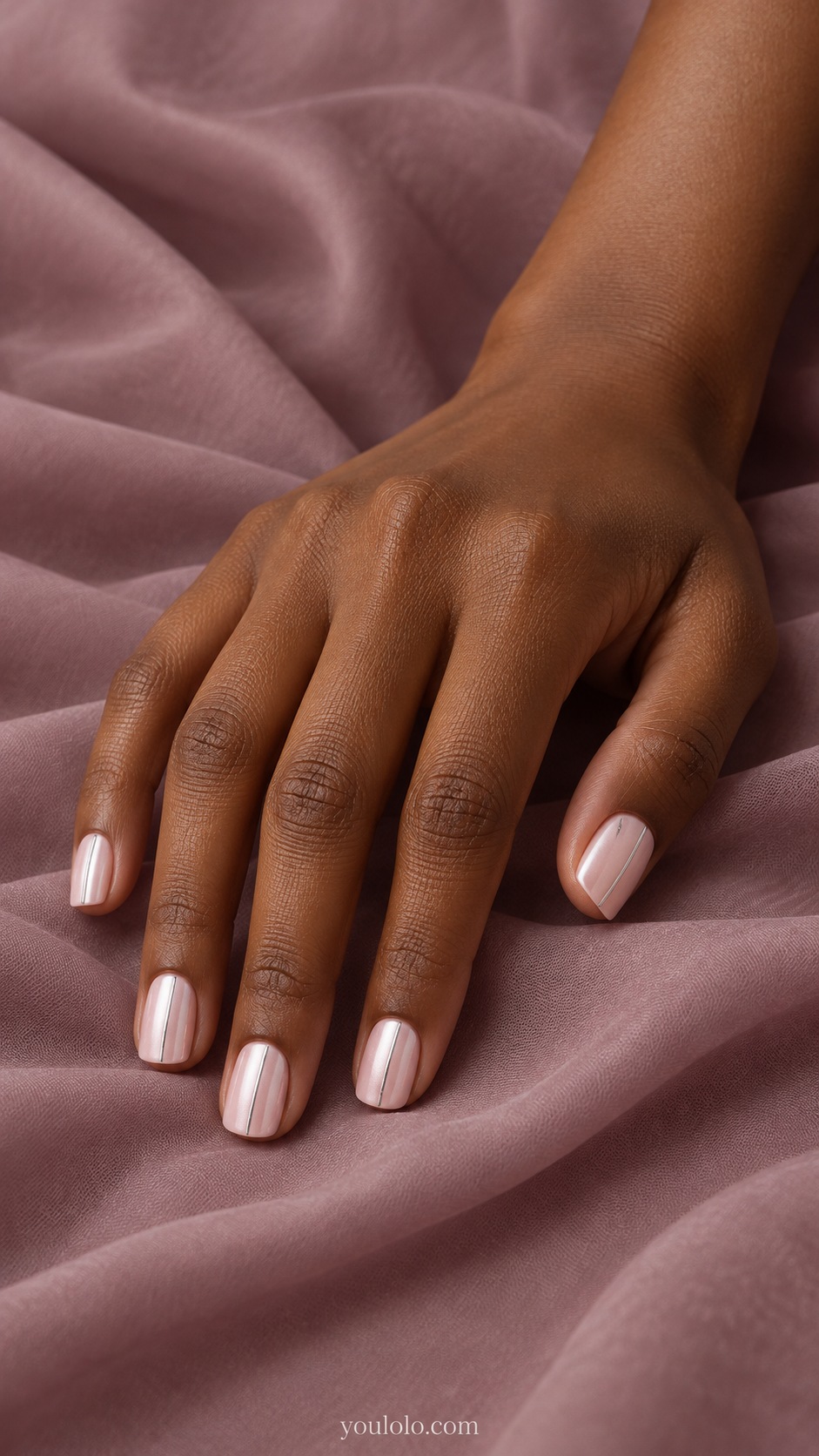 Short square pale pink pearl nails one very thin flat silver vertical line along one side, no studs