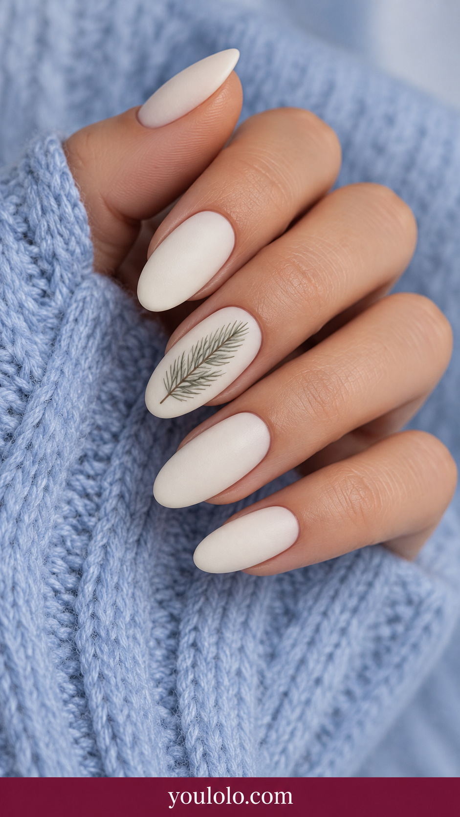 medium oval ivory cream nails one accent fine gray-green pine needle sprig flat painted, others plain ivory on a naturally relaxed adult hand