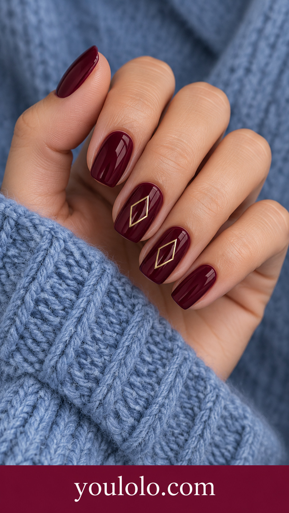 Maroon Open Diamond: medium squoval deep maroon nails two accents one thin muted gold open diamond outline centered on a naturally posed adult hand