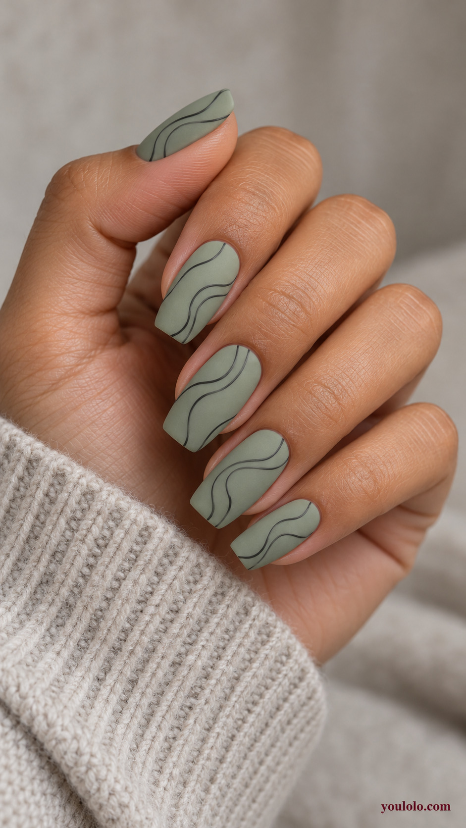 Fine Charcoal Contour Lines on a softly gathered feminine hand with a matte green manicure