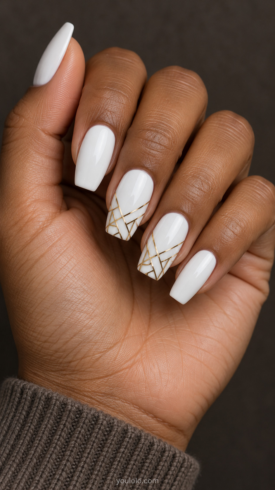 Medium coffin nails, white base, thin angular gold mosaic lines near the tips of two accent nails