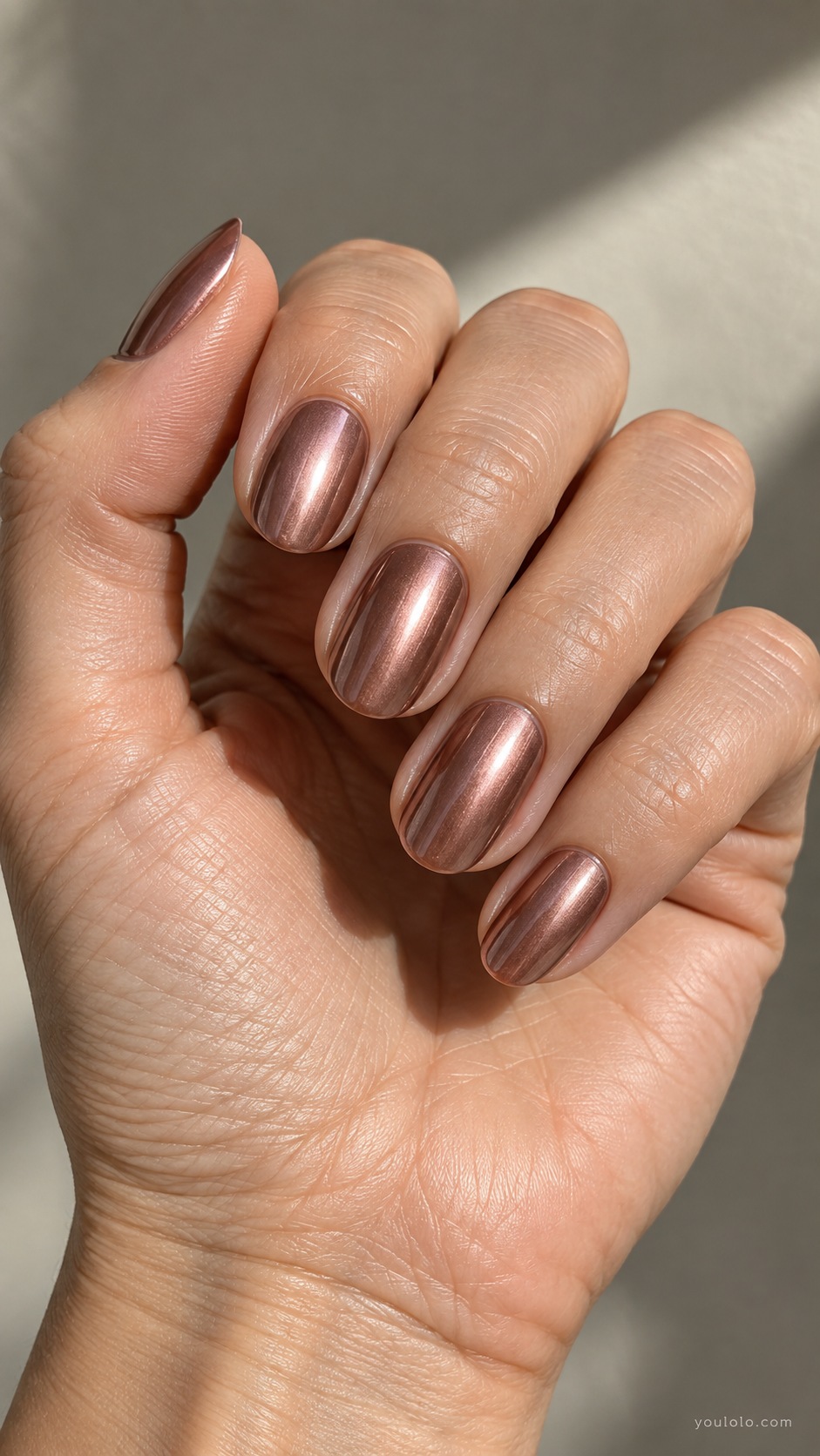 Rose Copper fall chrome nails — muted rosy copper chrome, pink brown metallic sheen not bright pink or orange, medium oval nails