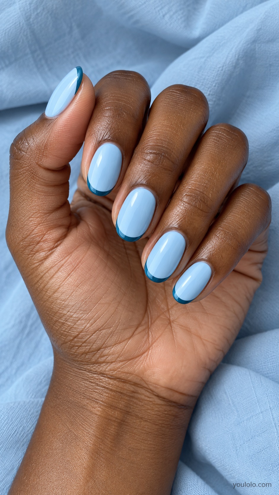 Medium oval nails pale sky blue cream with thin petrol teal blue edge at tip