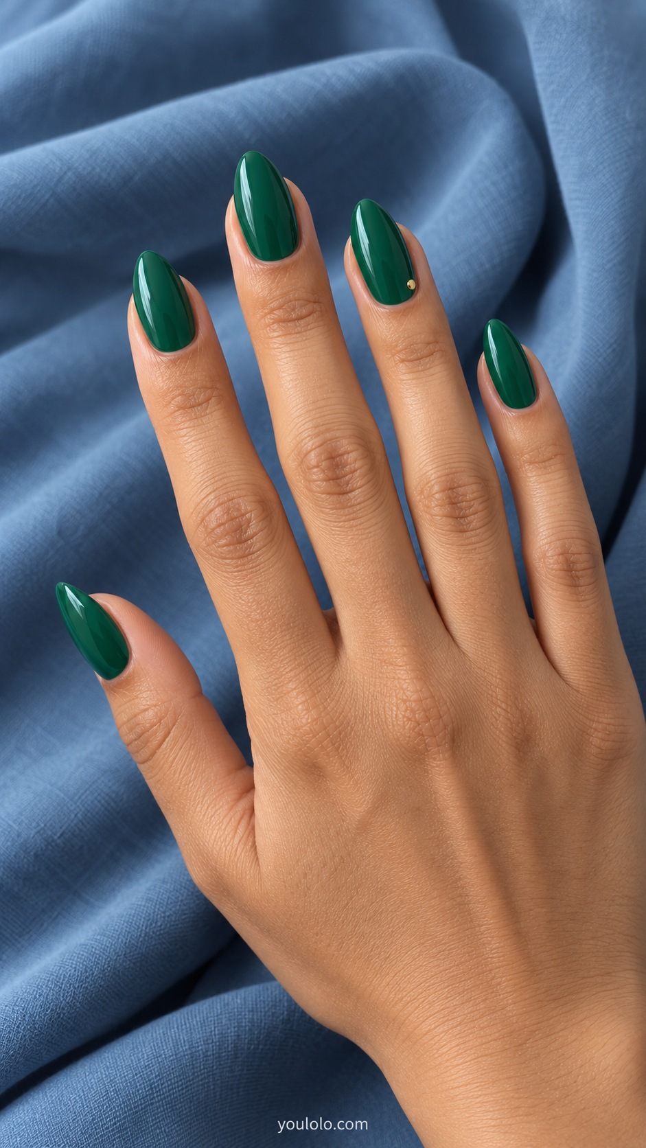 Medium almond acrylic extensions emerald green cream one tiny flat gold stud at outer corner of ring nail
