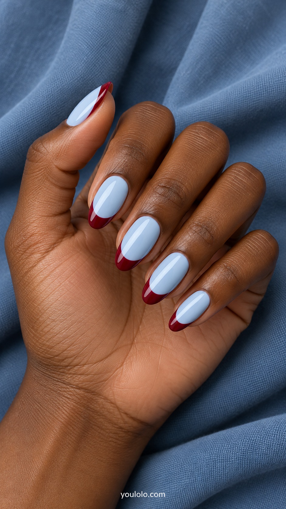 Medium almond nails pale ice blue base with deep berry red French tips