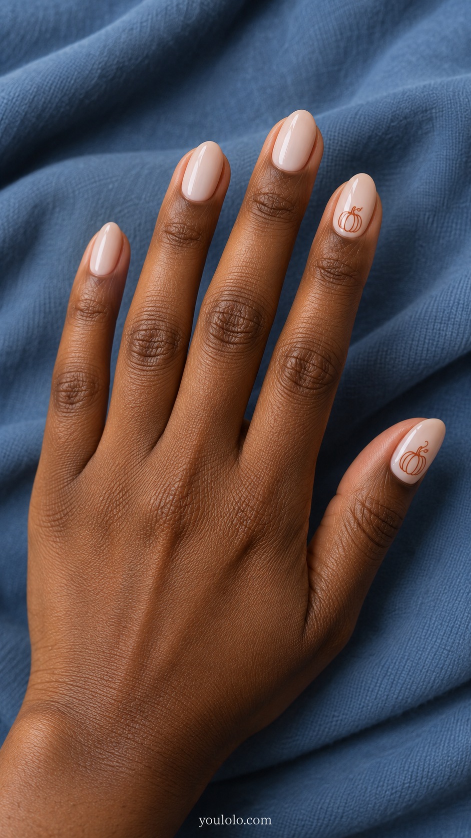 Short almond nails milky beige tiny simple terracotta pumpkin outlines on ring and thumb