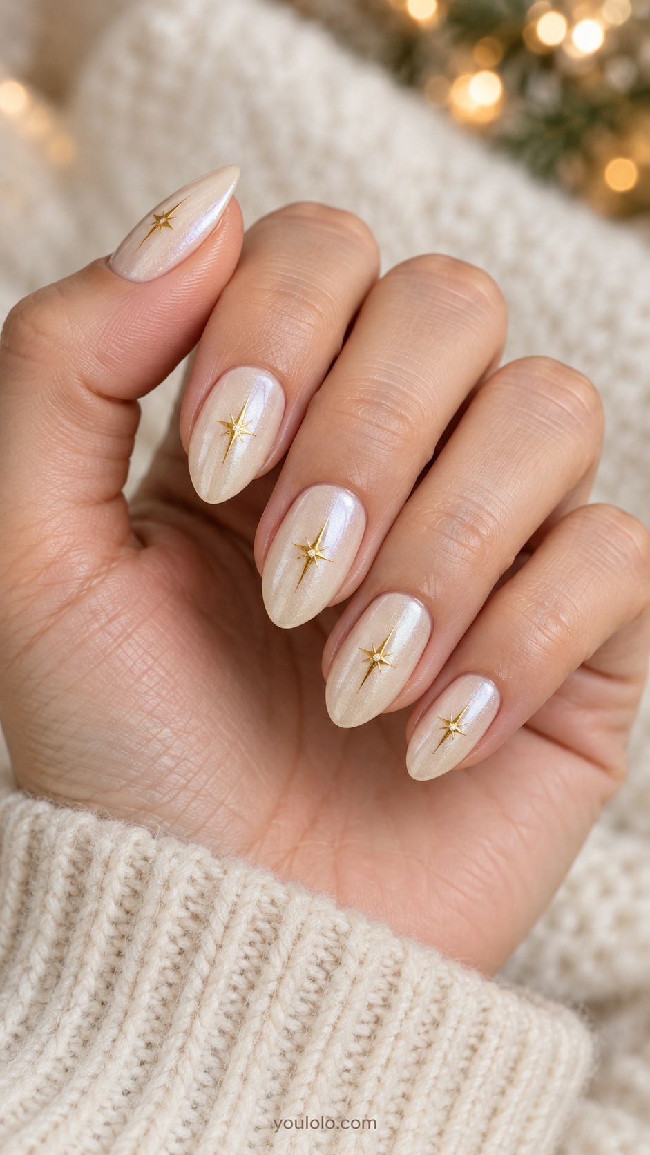 Medium almond ivory pearl sheen one fine gold four point elongated star near center each nail