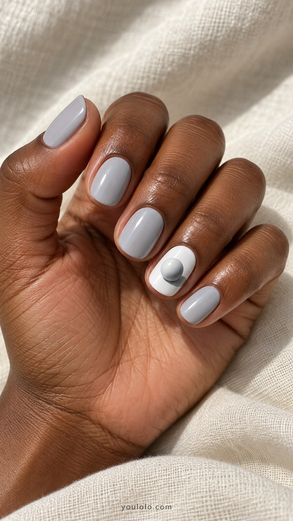 Floating Pearl Illusion: short round pale gray nails, one painted white sphere with gray cast shadow and highlight, no actual bead